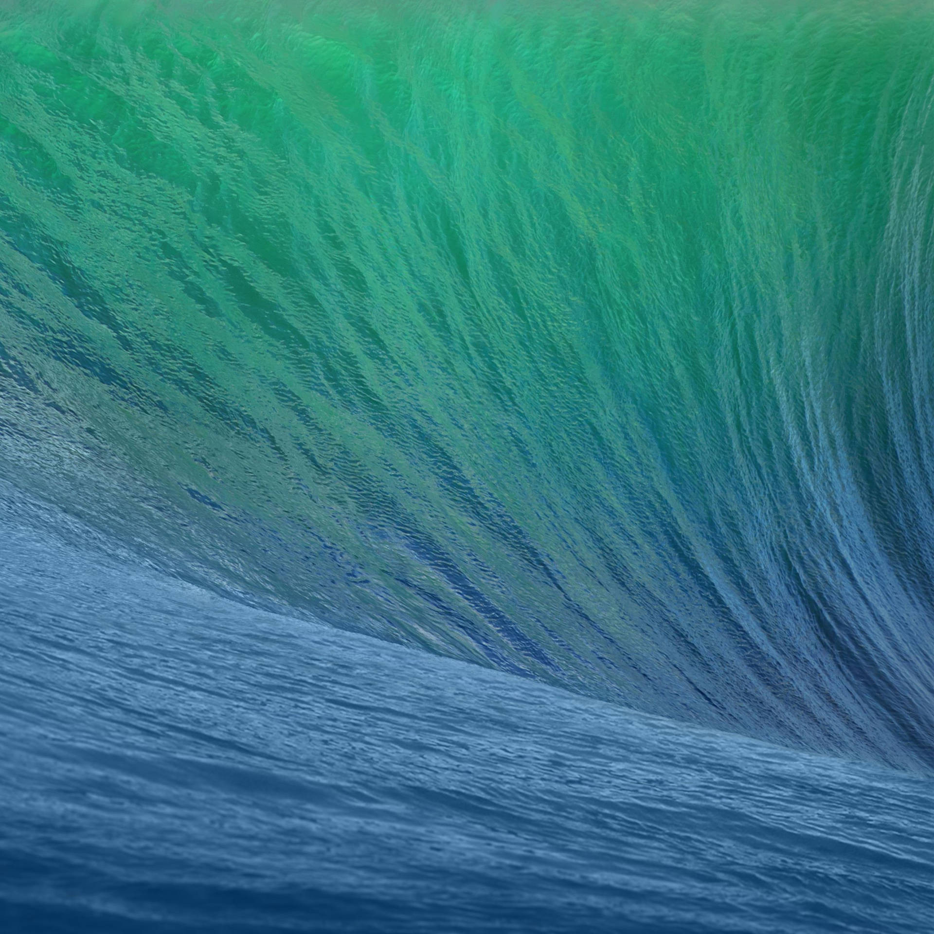 高聳的海浪捲曲成玻璃般的綠藍色管狀。 — iPad 壁紙