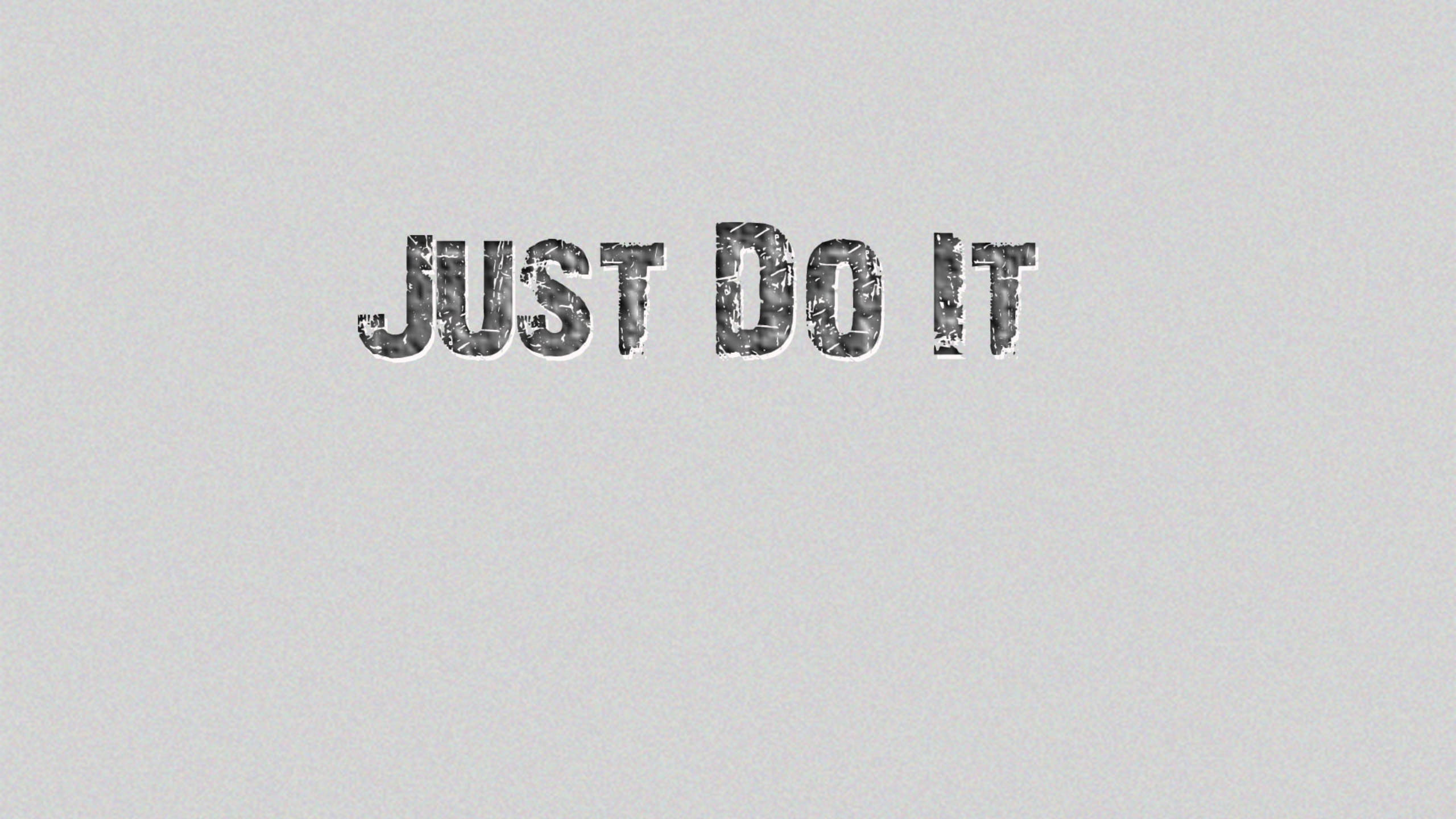 就去做吧 桌布 壁紙 — 「just do it」這個短語以粗體紋理字體顯示在純淺灰色背景上。