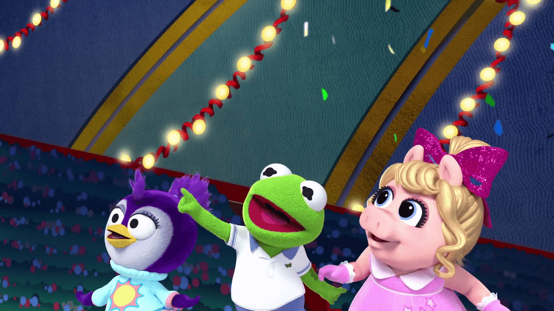 babies 桌布 壁紙 — Kermit、Miss Piggy 和一隻紫色企鵝在節日燈串下慶祝，周圍有五彩紙屑飄落。