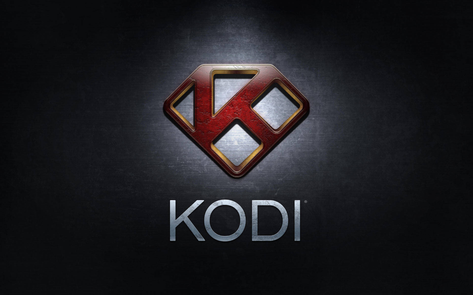 科迪 桌布 壁紙 — Kodi 標誌在帶有聚光燈效果的深色紋理背景上閃耀著金屬紅和金色點綴。