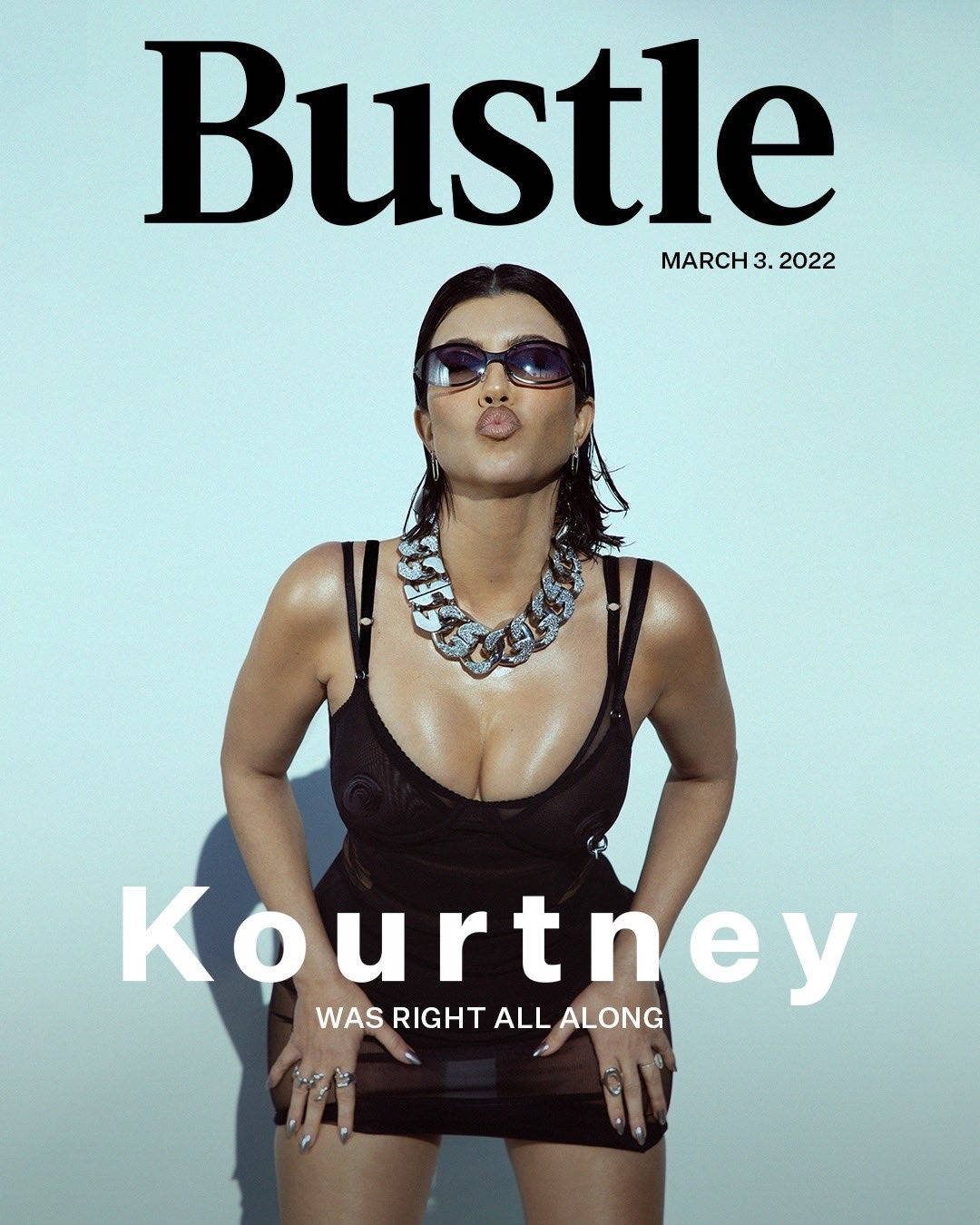 Kourtney 桌布 壁紙 — Kourtney Kardashian 身穿黑色連身裙和粗鏈項鍊，在淺藍色攝影棚背景前為 Bustle 雜誌自信地擺姿勢。