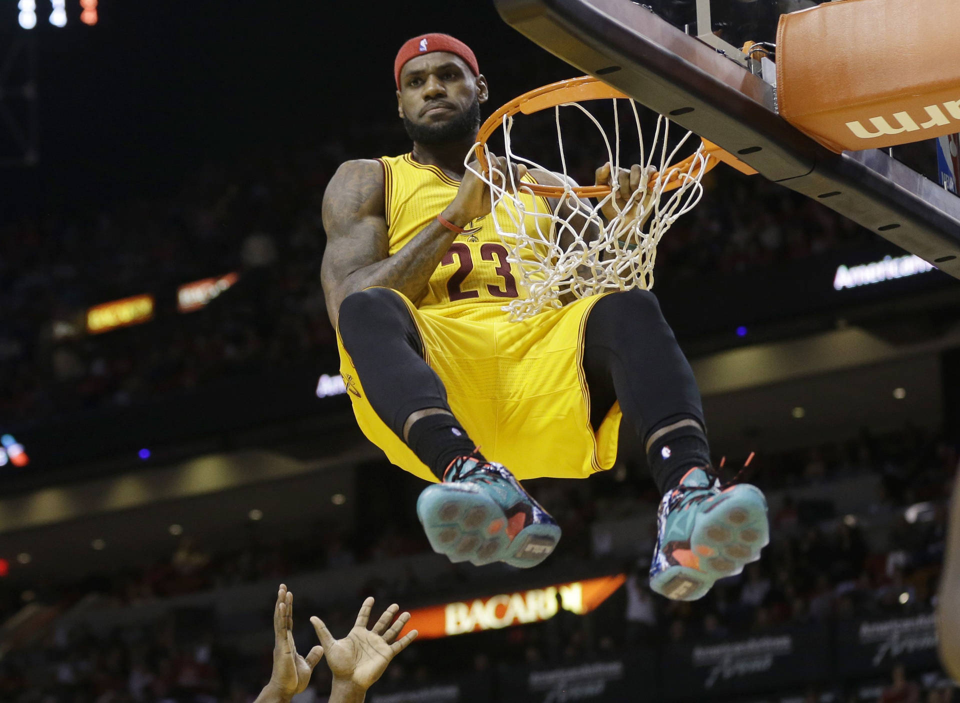 勒布朗詹姆斯身穿黃色球衣空中灌籃，背景有觀眾。 — King Lebron James 壁紙