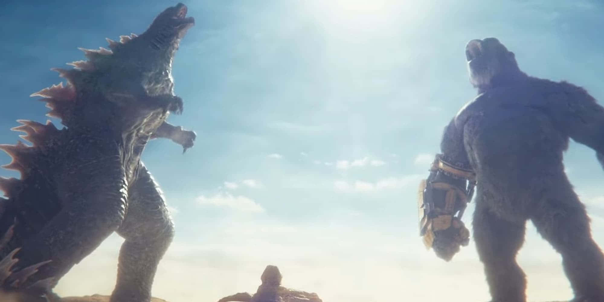 Godzilla X Kong The New Empire 桌布 壁紙 — 兩隻巨大的怪獸哥吉拉和金剛在明亮的陽光下互相咆哮。