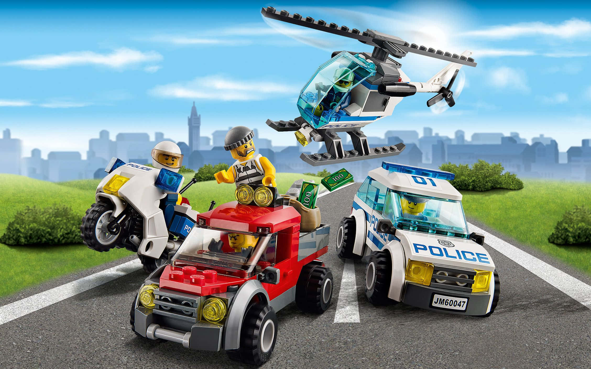 樂高 桌布 壁紙 — LEGO 警察追捕場景，直升機、摩托車和汽車在陽光明媚的城市道路上追趕一輛紅色卡車。