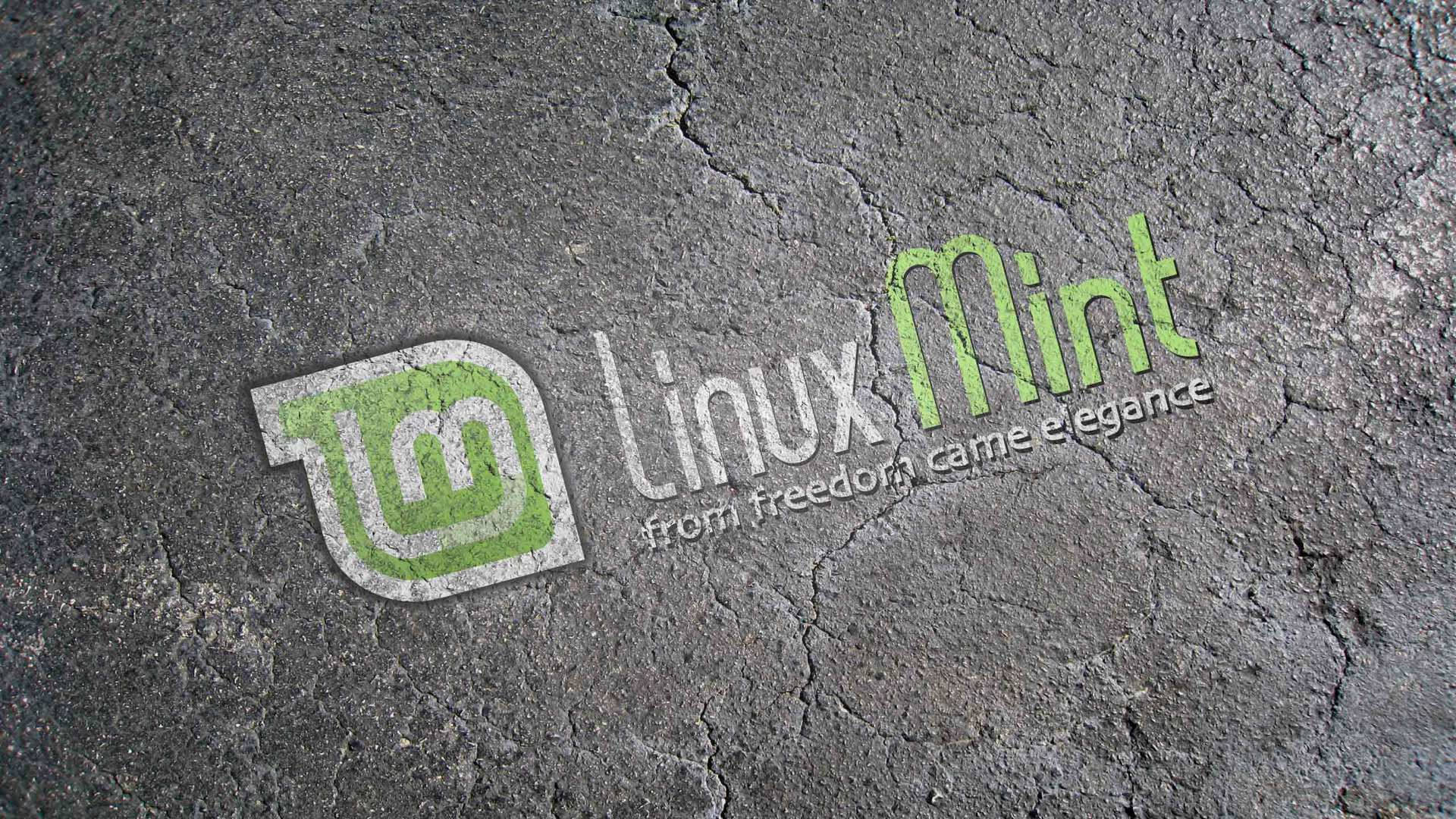 Linux 桌布 壁紙 — Linux Mint 標誌和標語蝕刻在裂開的灰色混凝土上，帶有綠色和白色文字。