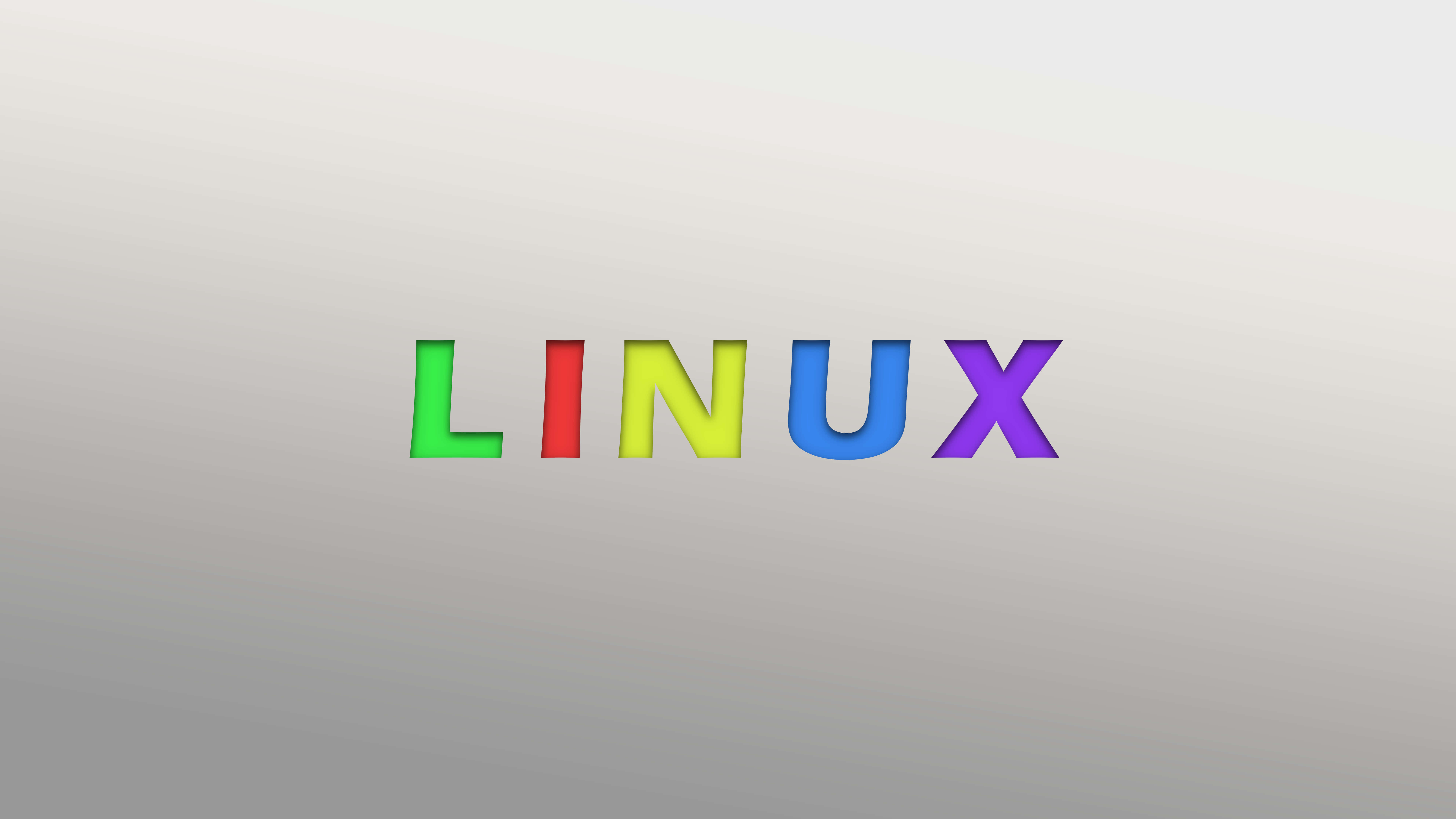 Linux 桌布 壁紙 — 「Linux」一詞以粗體彩虹色呈現在柔和的灰色漸變背景上。