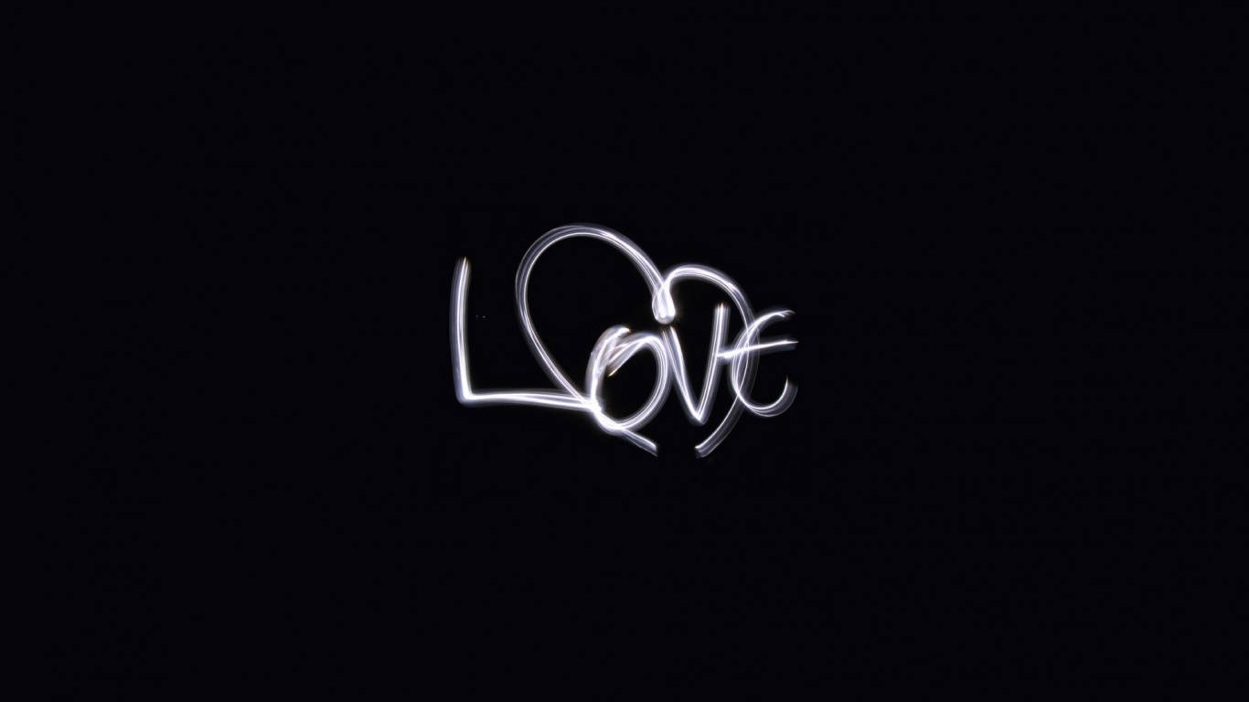 可愛黑色動圖 桌布 壁紙 — 「love」一詞以發光的白色光跡寫在純黑色背景上。