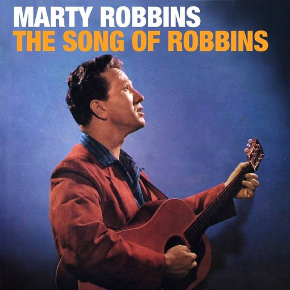 吉他動圖 桌布 壁紙 — Marty Robbins 抬頭仰望，手持木吉他，背景為深藍色攝影棚，並有粗體專輯標題文字。