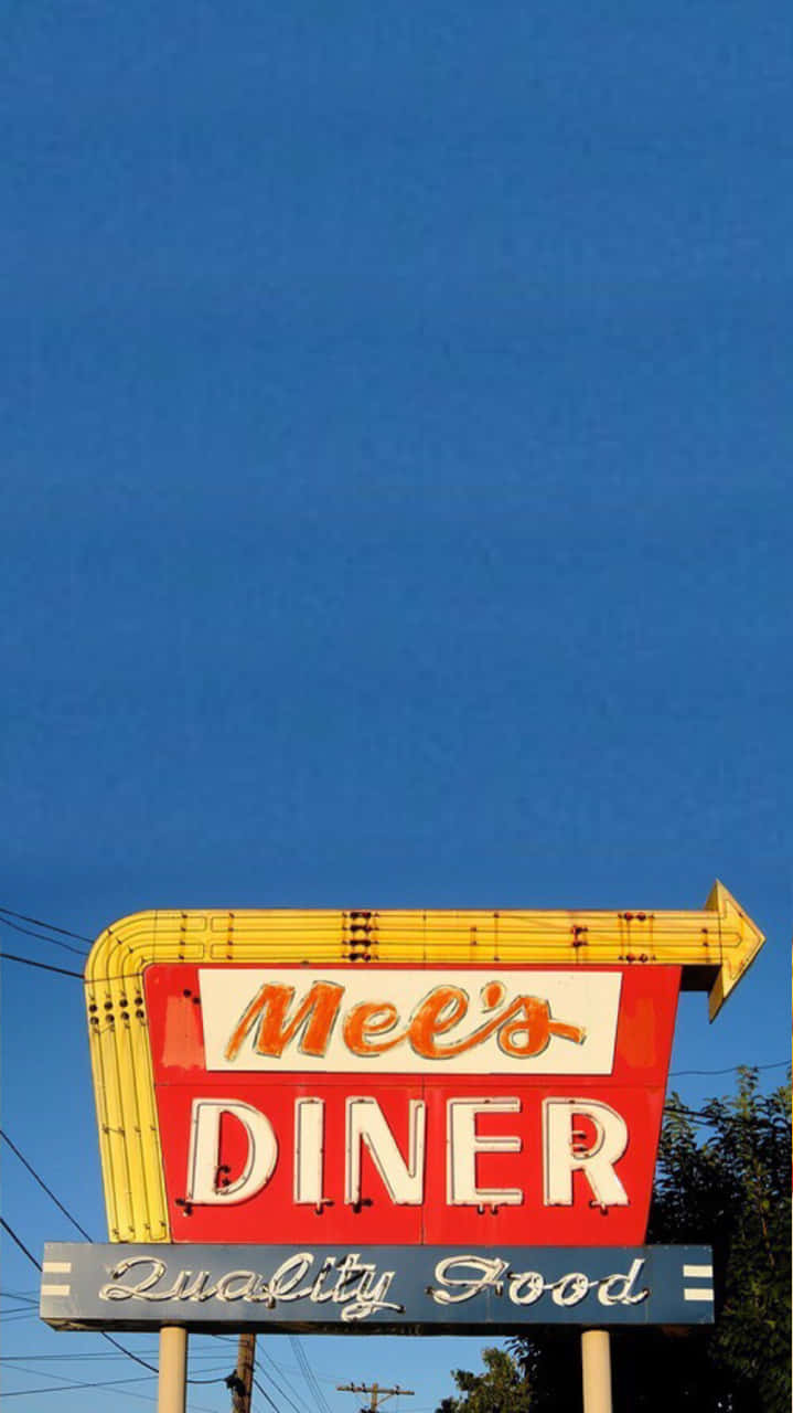 60s 桌布 壁紙 — Mee's Diner 的復古紅黃霓虹招牌指向右方，背景是清澈的藍天。