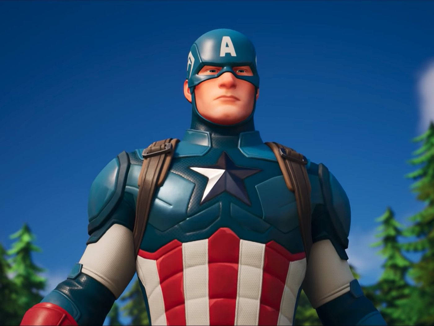 美國隊長身穿經典服裝，在戶外與松樹和藍天一起站立。 — Fortnite 壁紙