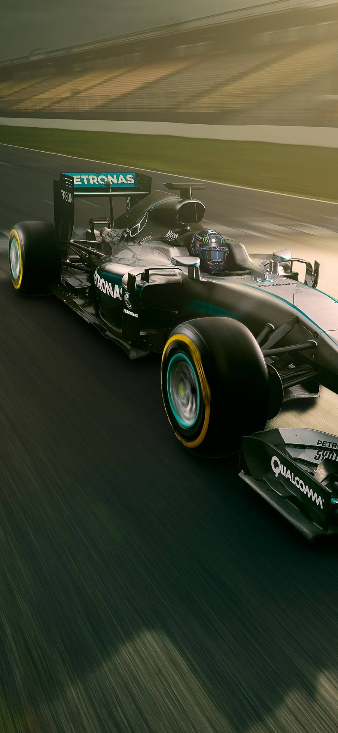 Mercedes F1 iPhone賽道 壁紙 — 一架時尚的黑色和藍綠色一級方程式賽車在賽道上高速飛馳，動態模糊傳達出強烈的速度感。