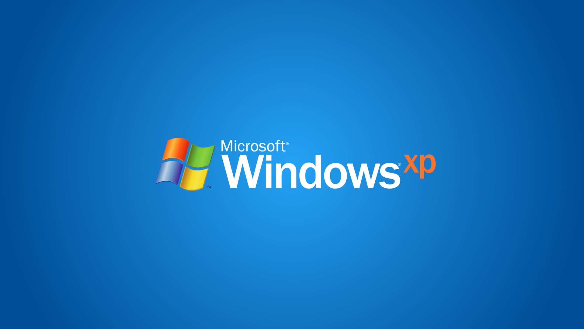  壁紙 — Microsoft Windows XP 標誌居中於純藍色漸變背景上。