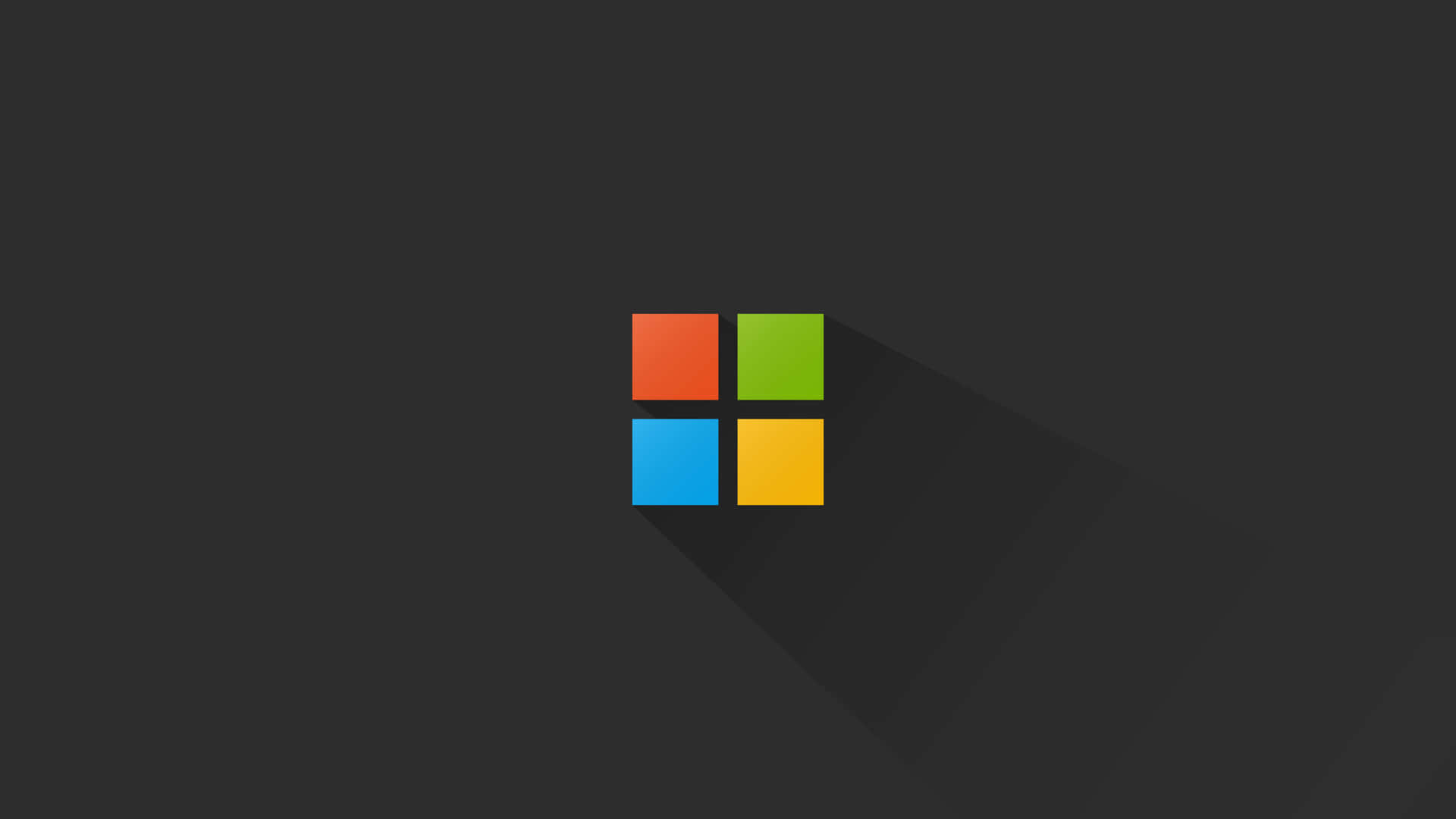 Microsoft 標誌，四個彩色正方形在深灰色背景上。 — Microsoft 壁紙