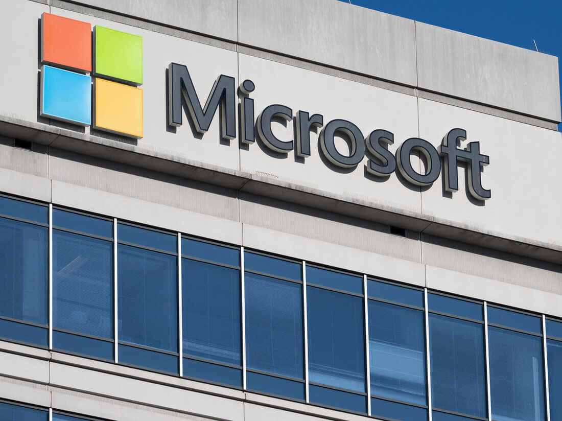 Microsoft 企業大樓，帶有標誌和玻璃窗，藍天白雲 — Microsoft 壁紙