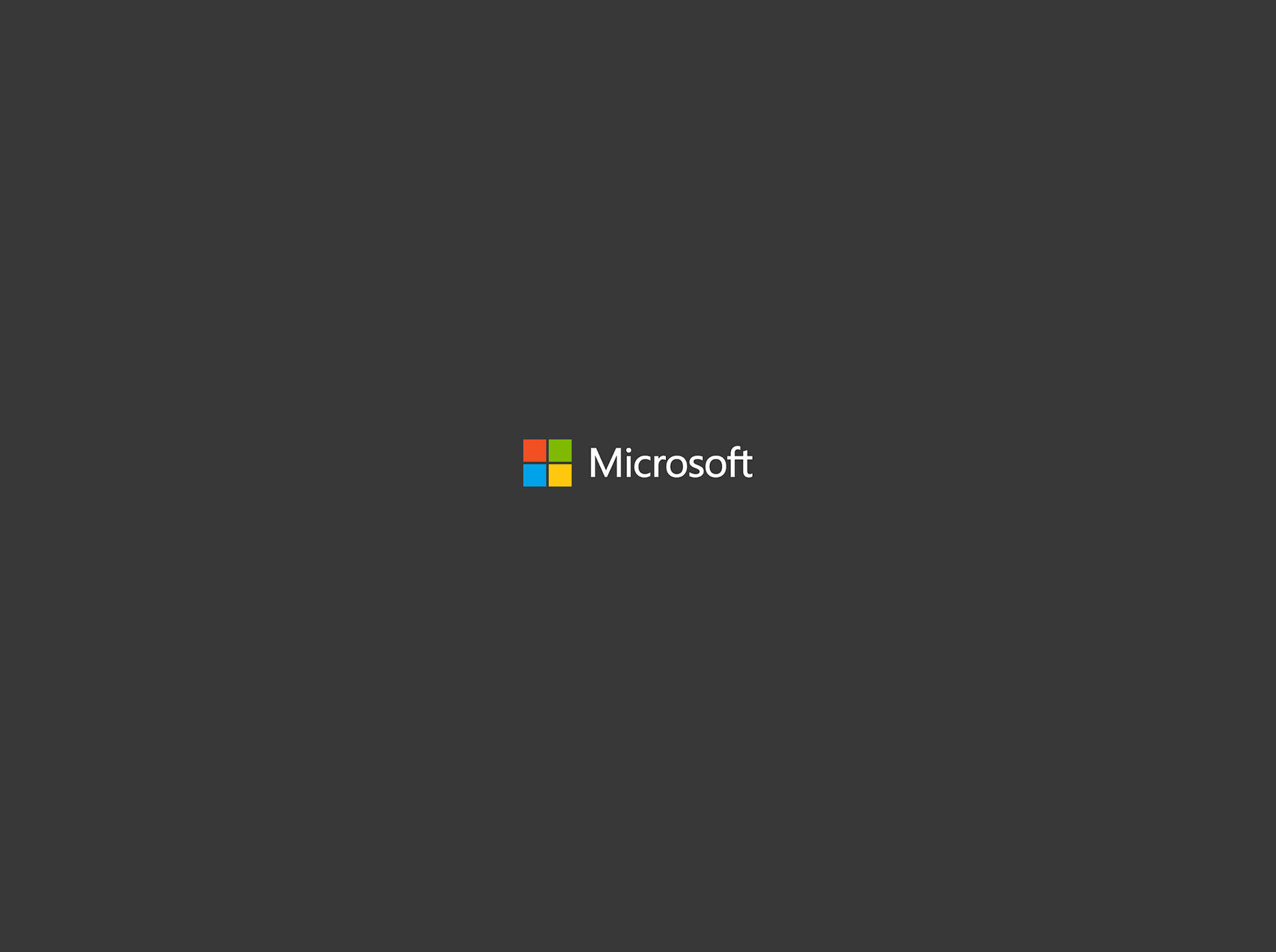 Microsoft 標誌，深灰色背景上有四個彩色方塊 — Microsoft 壁紙