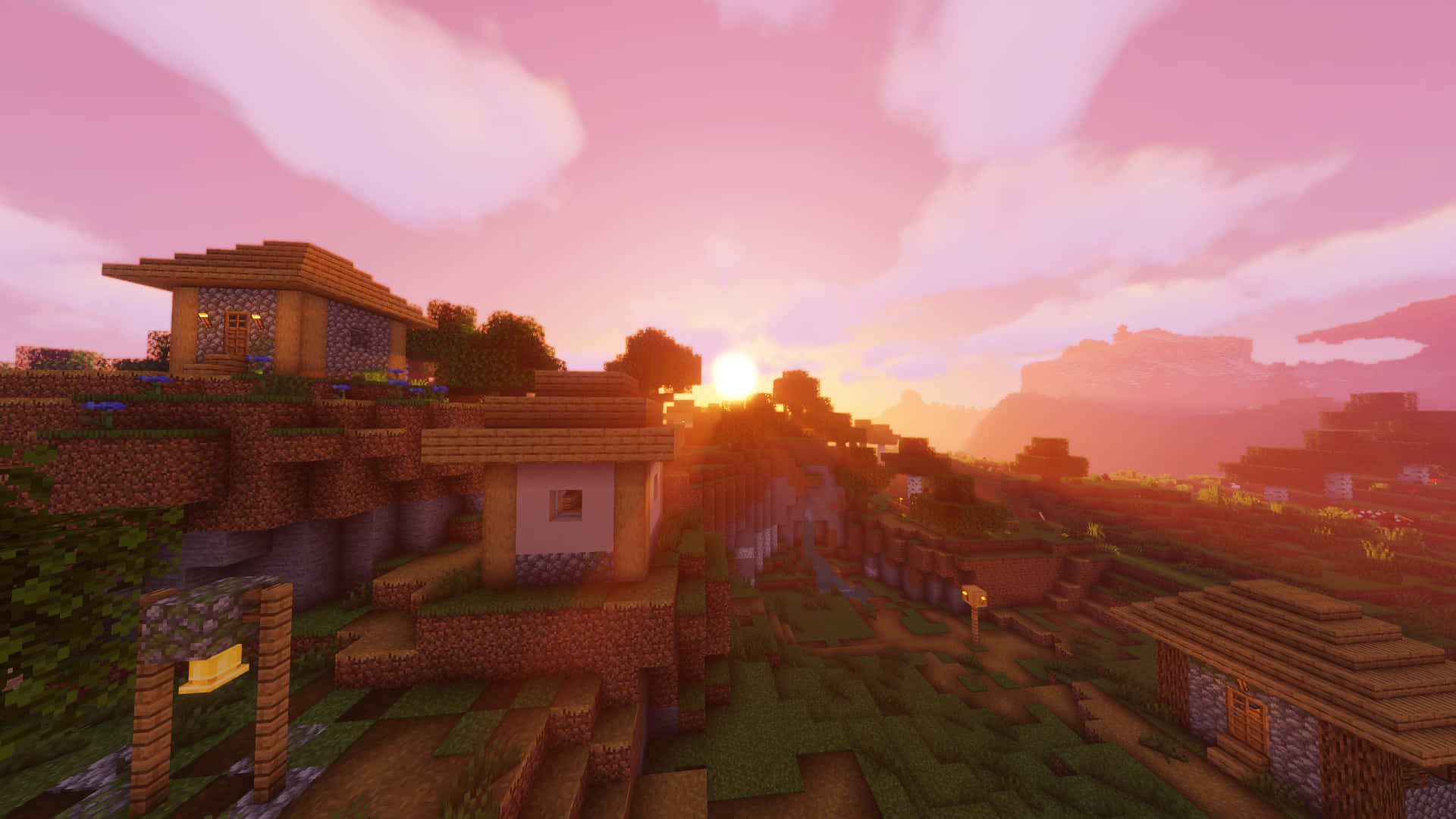 Minecraft Villages 桌布 壁紙 — Minecraft村莊在日落時分，階梯狀山丘上有方塊房屋，天空呈粉紅色。