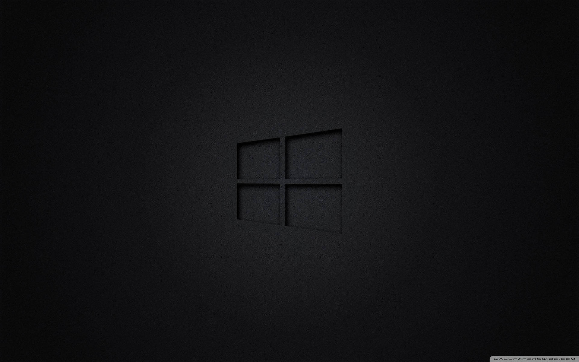 Windows標誌壓印在深色紋理牆壁上，光線柔和。 — 鎖屏 壁紙
