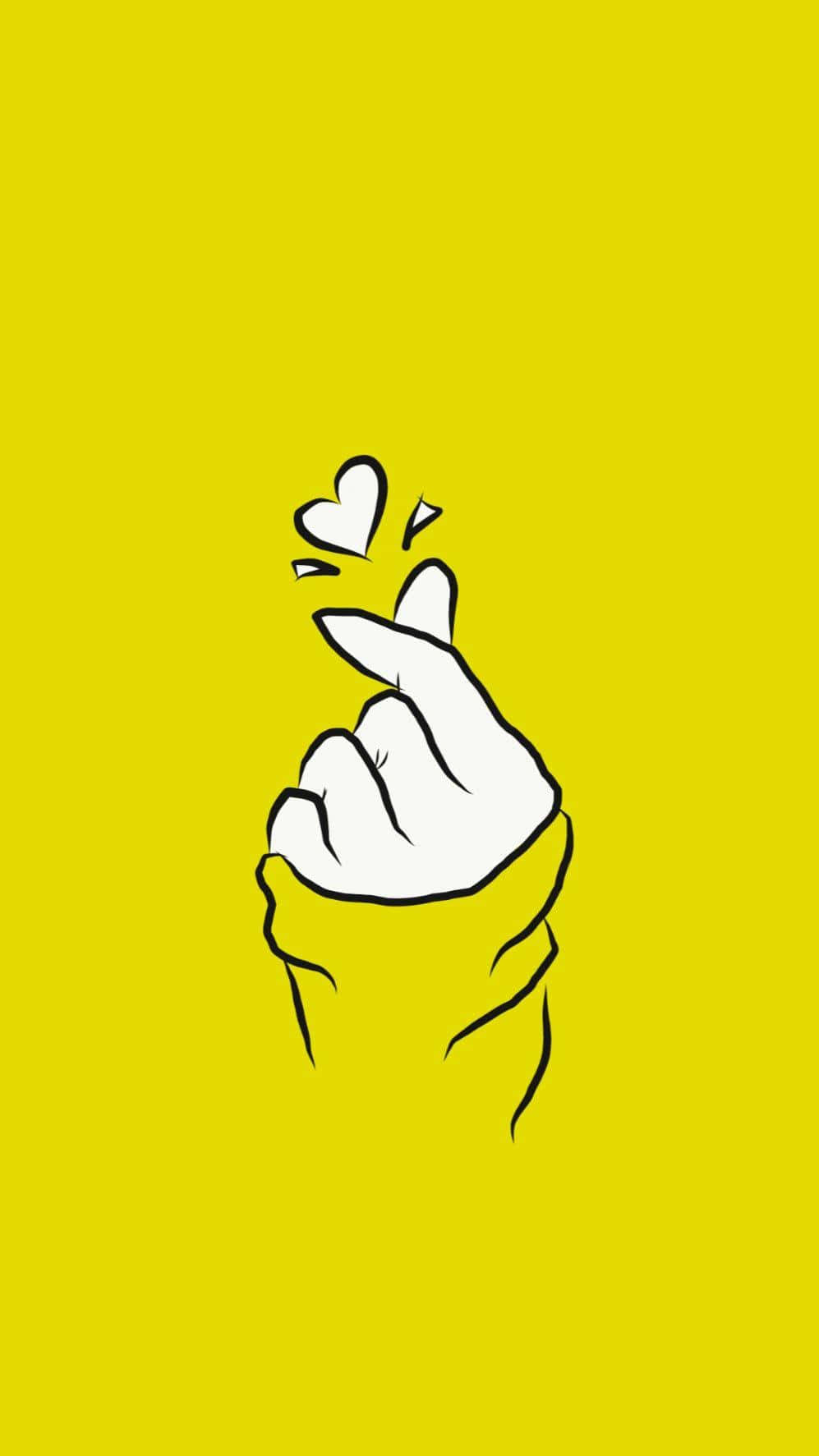 Yellow Heart 桌布 壁紙 — 一隻極簡風格的白色手在鮮黃色背景上做出心形手勢，上方有一個小心形。