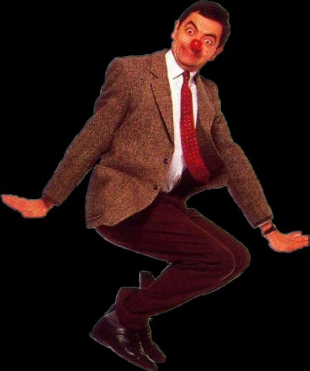 搞笑 桌布 壁紙 — Mr. Bean 身穿棕色西裝和紅色領帶，在黑色背景前，帶著滑稽的小丑鼻子和睜大的眼睛，在空中跳躍。