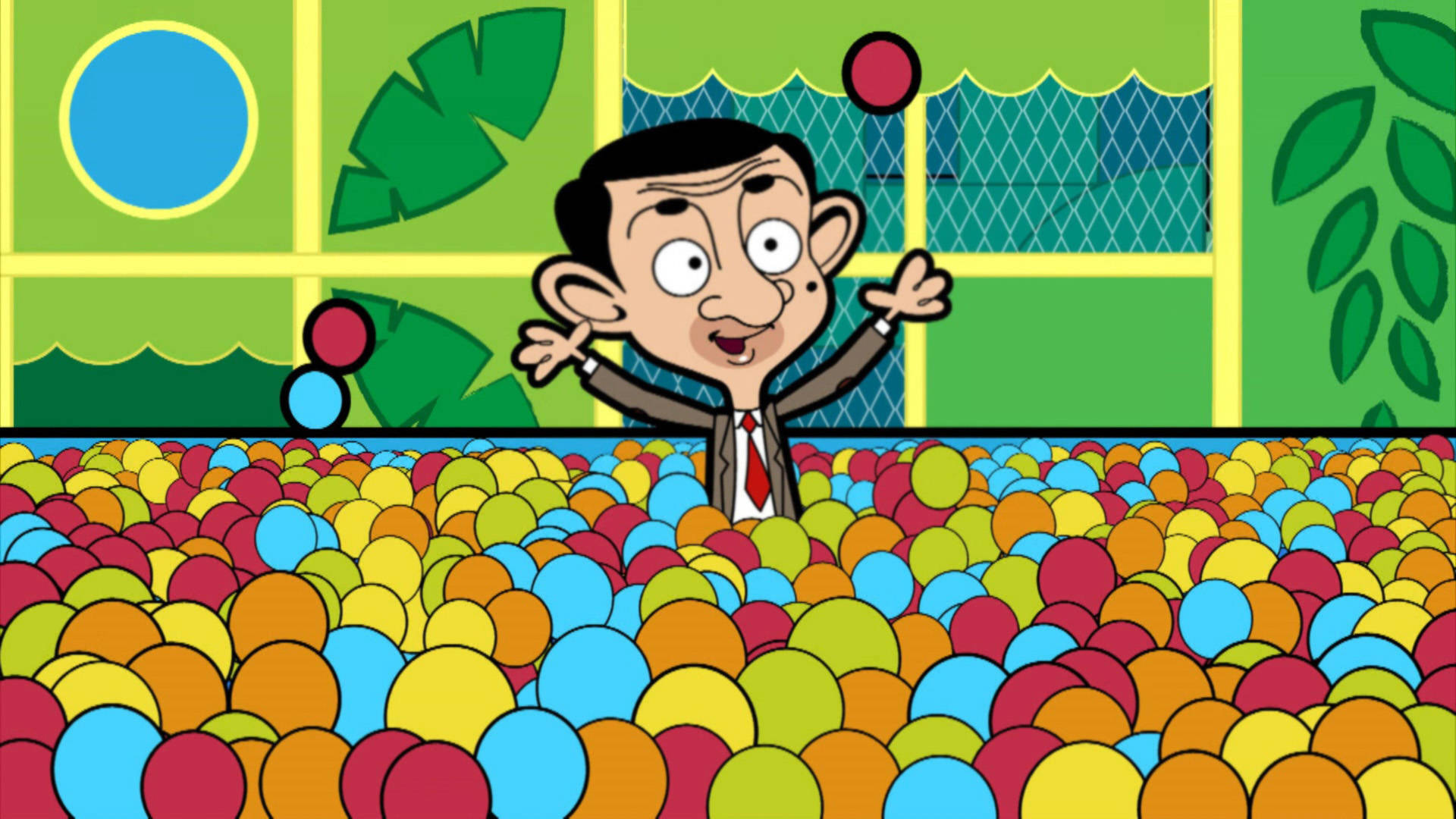 豆豆先生 桌布 壁紙 — Mr Bean 開心地站在一個色彩繽紛的球池中，高舉雙臂，周圍是充滿活力的彩色球。