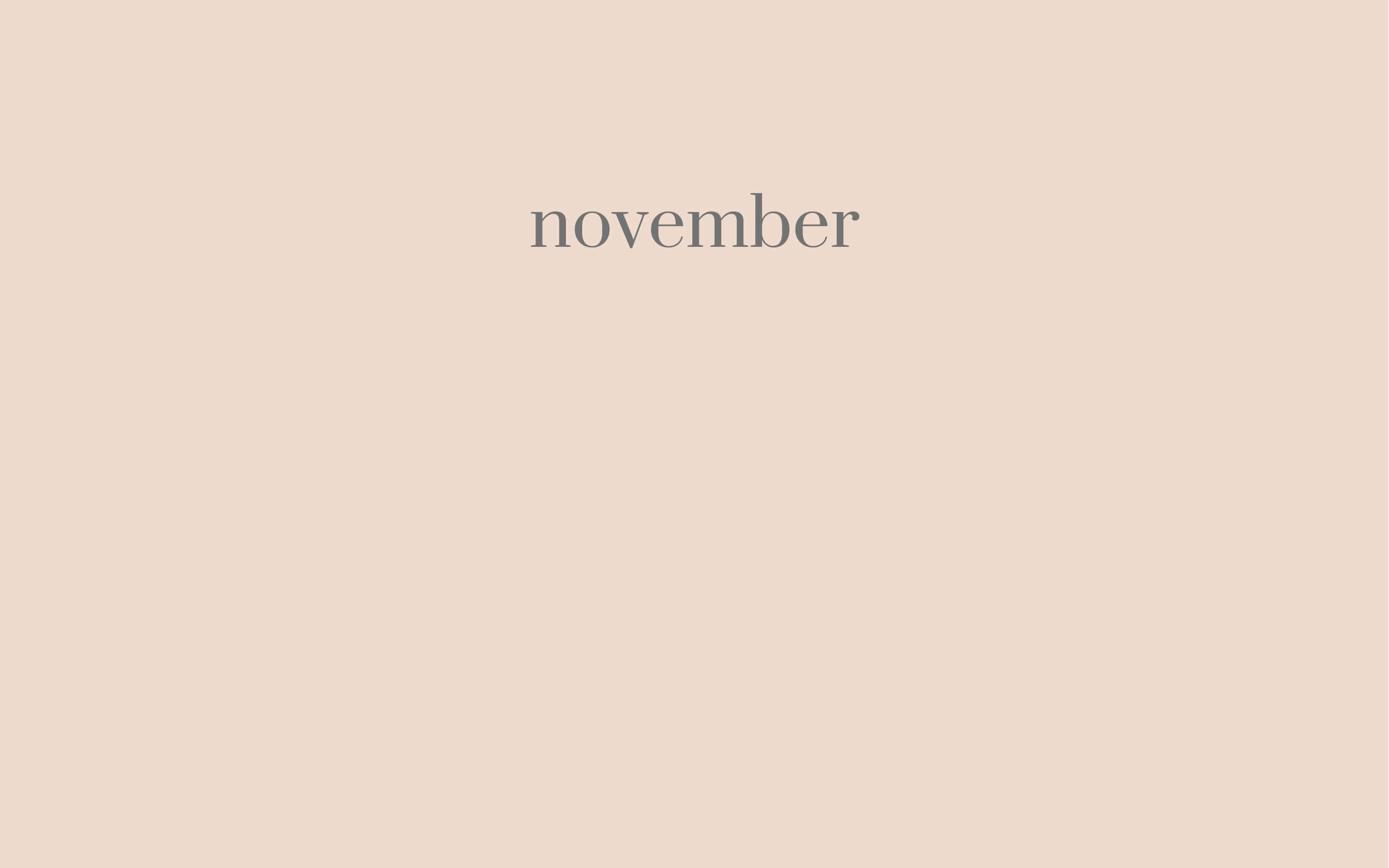 Aesthetic November 桌布 壁紙 — 「november」一詞居中於簡約米色背景，搭配柔和灰色文字。