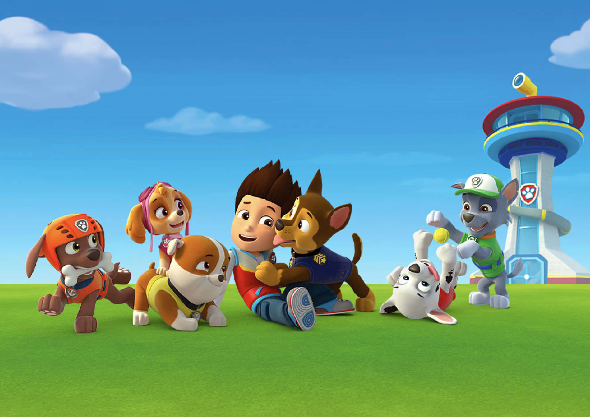 Paw Patrol 角色在塔附近的草地上玩耍 — 汪汪隊立大功 GIF 壁紙