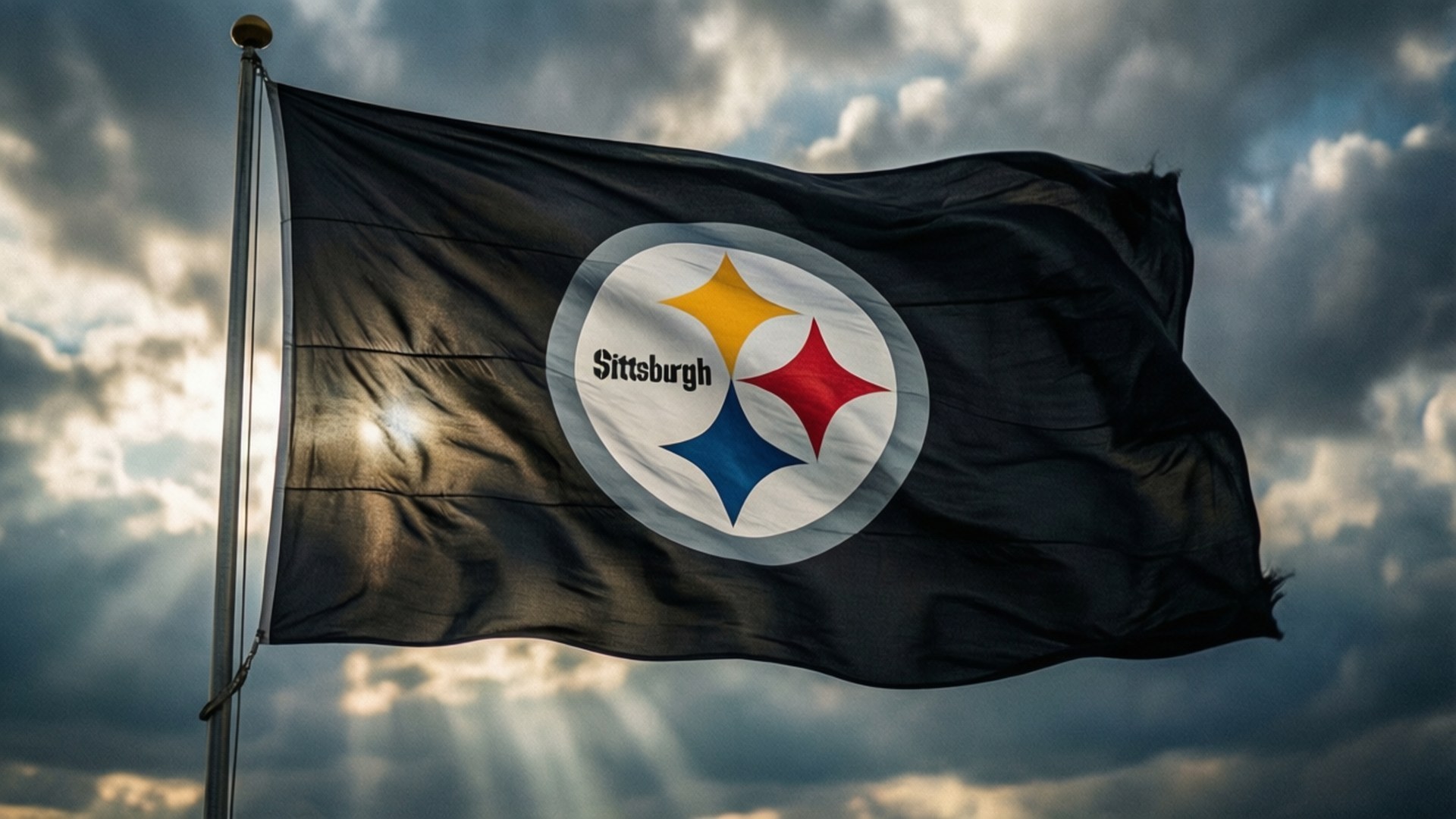 Steelers Flag in Wind 壁紙 — 匹茲堡鋼人隊旗幟在戲劇性的多雲天空和穿透的陽光下大膽飄揚。