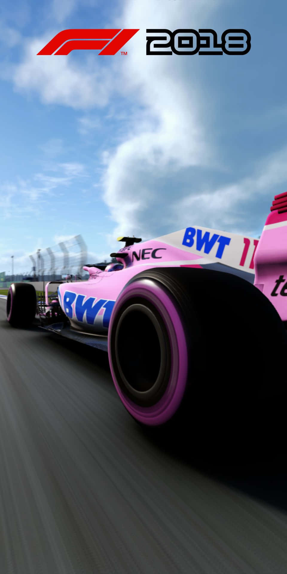 粉紅色和藍色的一級方程式賽車在藍天下疾馳在賽道上。 — F1 壁紙