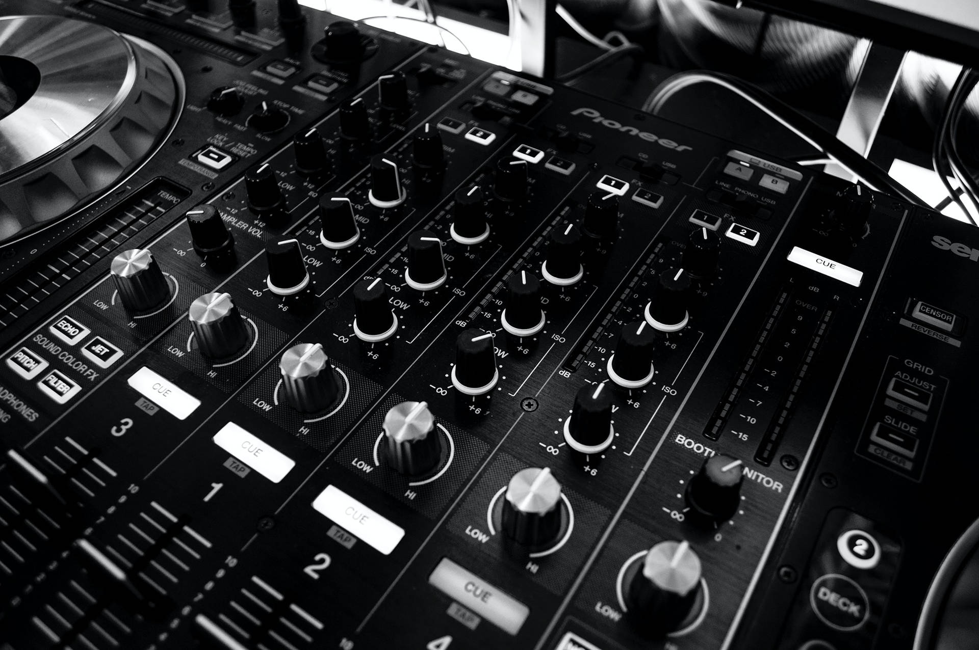  壁紙 — Pioneer DJ 混音器的黑白特寫鏡頭，包含旋鈕、推桿和唱盤，在錄音室環境中。