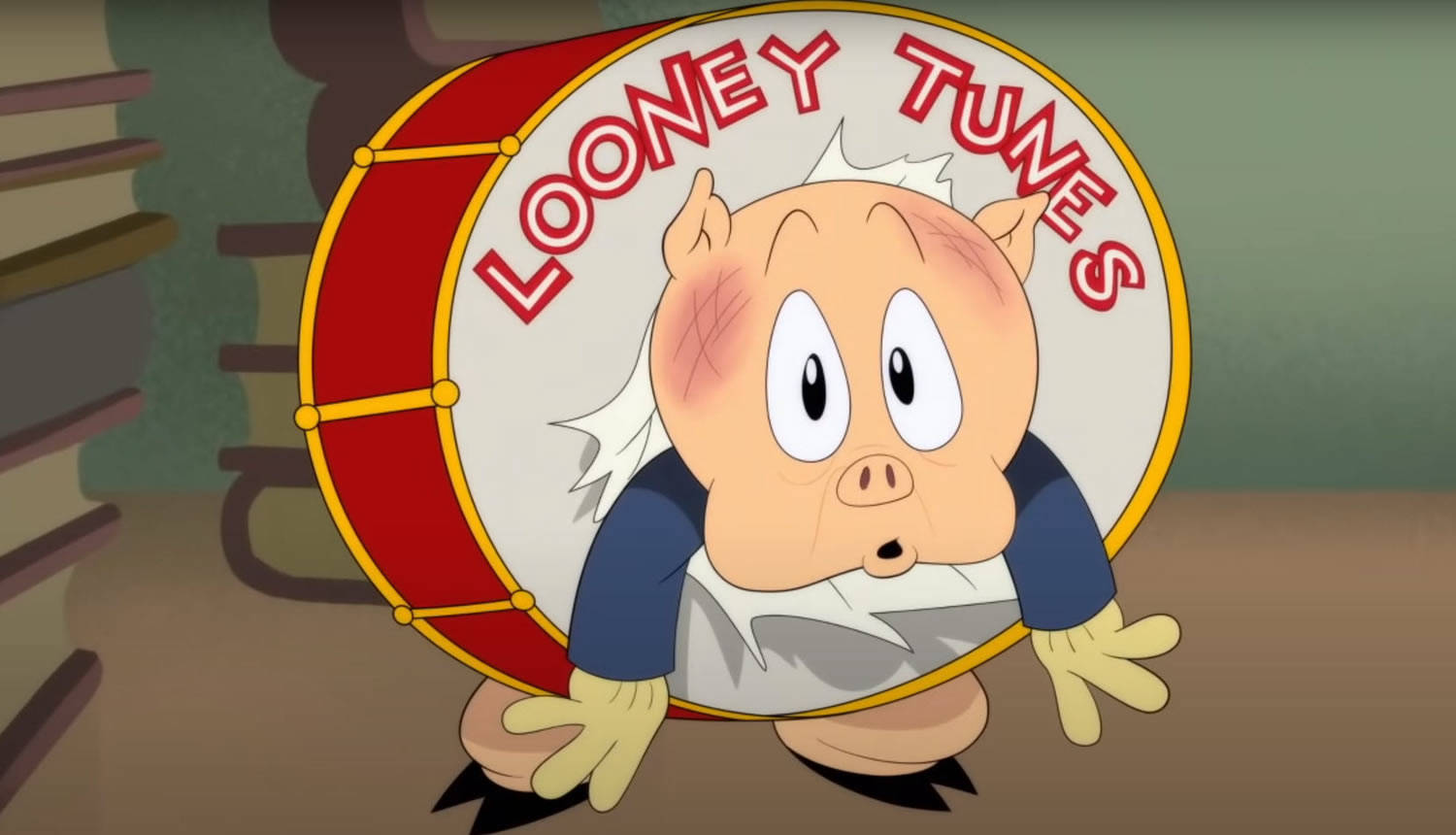 Cartoon 桌布 壁紙 — Porky Pig 從一個紅色鼓後面探出頭來，鼓的白色頭上用紅色字母寫著「Looney Tunes」。