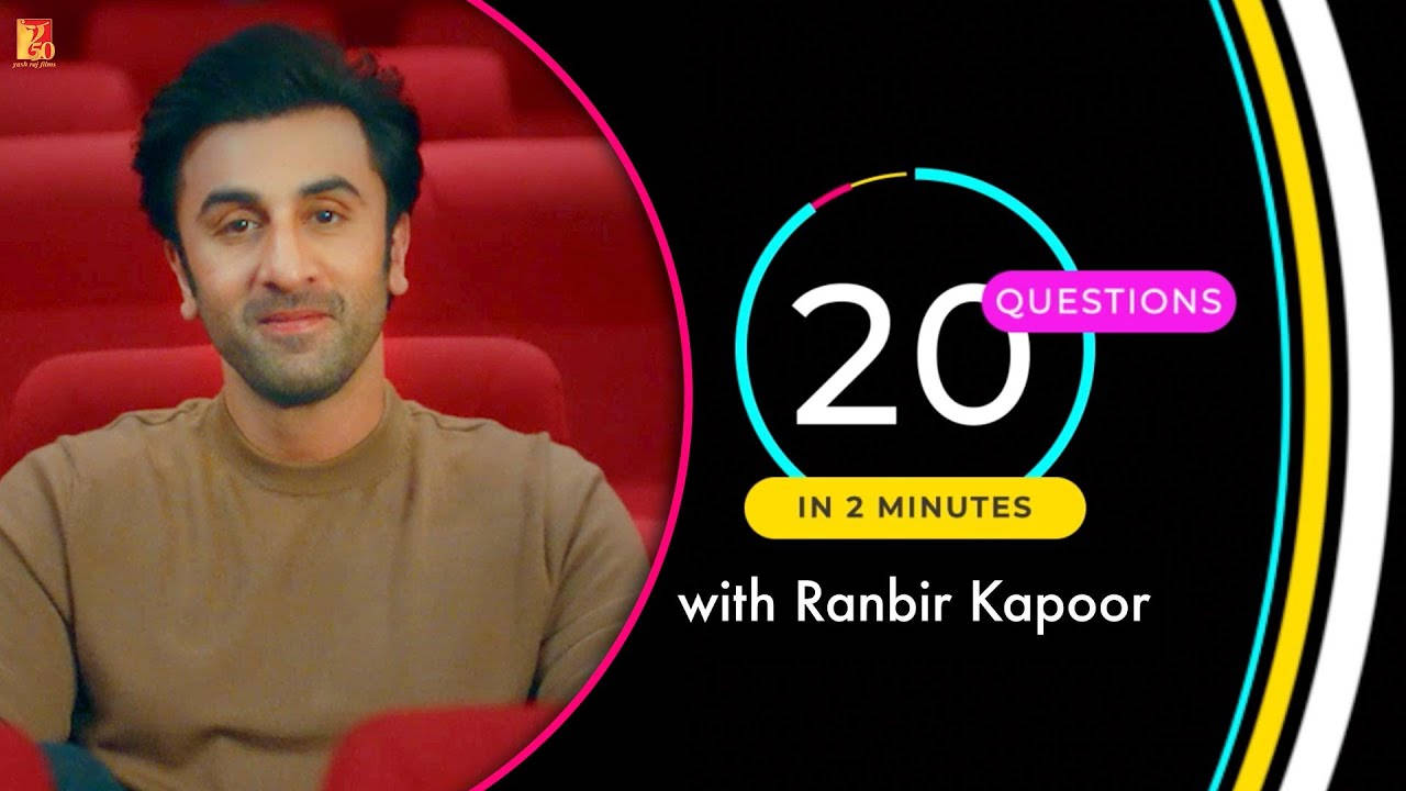 電影動圖 桌布 壁紙 — Ranbir Kapoor 在紅色劇院座位上微笑，旁邊是一個色彩繽紛的圖案，上面寫著「2分鐘內20個問題」。
