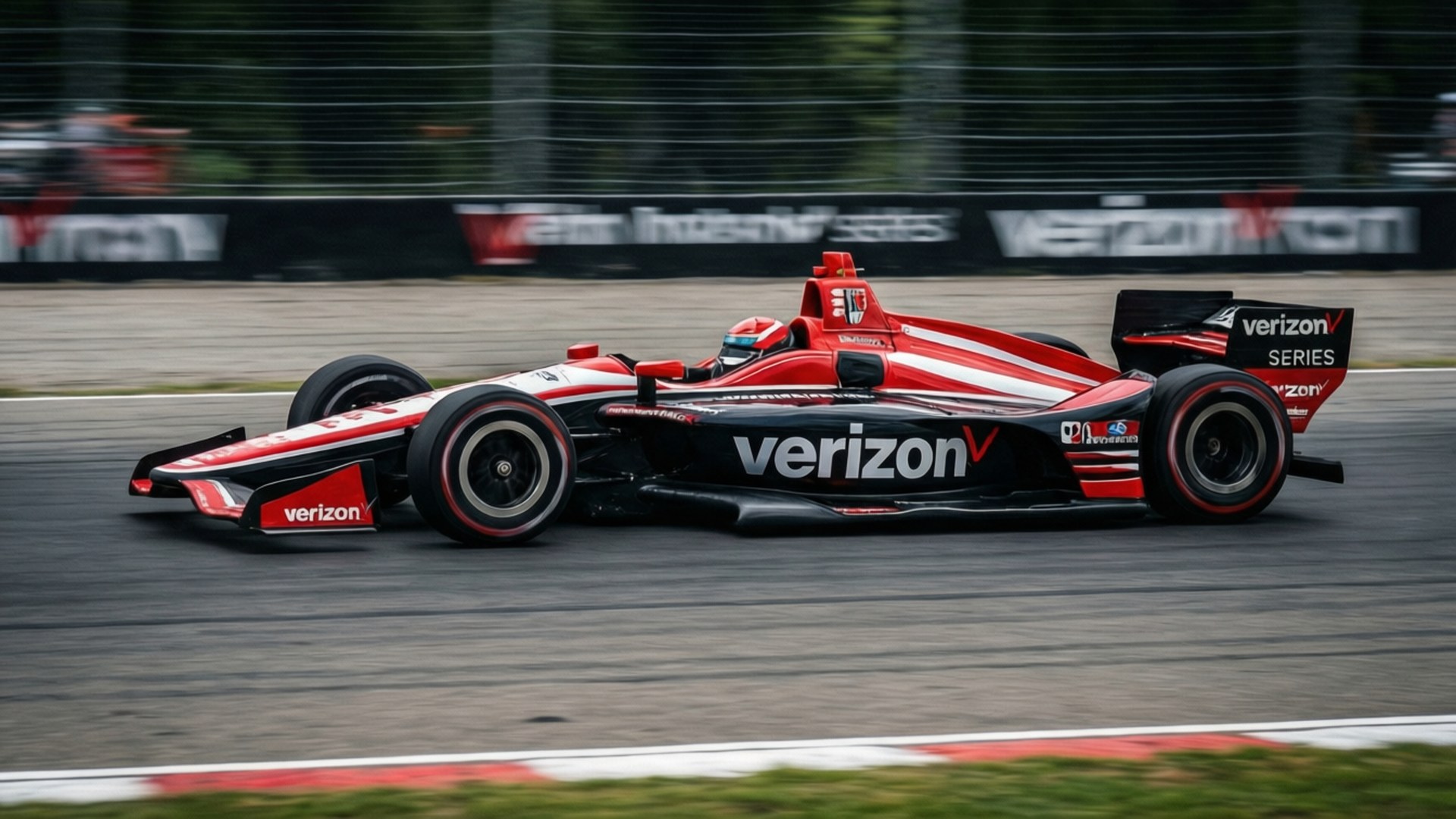威訊 桌布 壁紙 — 一輛紅黑相間的Verizon IndyCar在賽道上疾馳，動態模糊傳達出高速感。