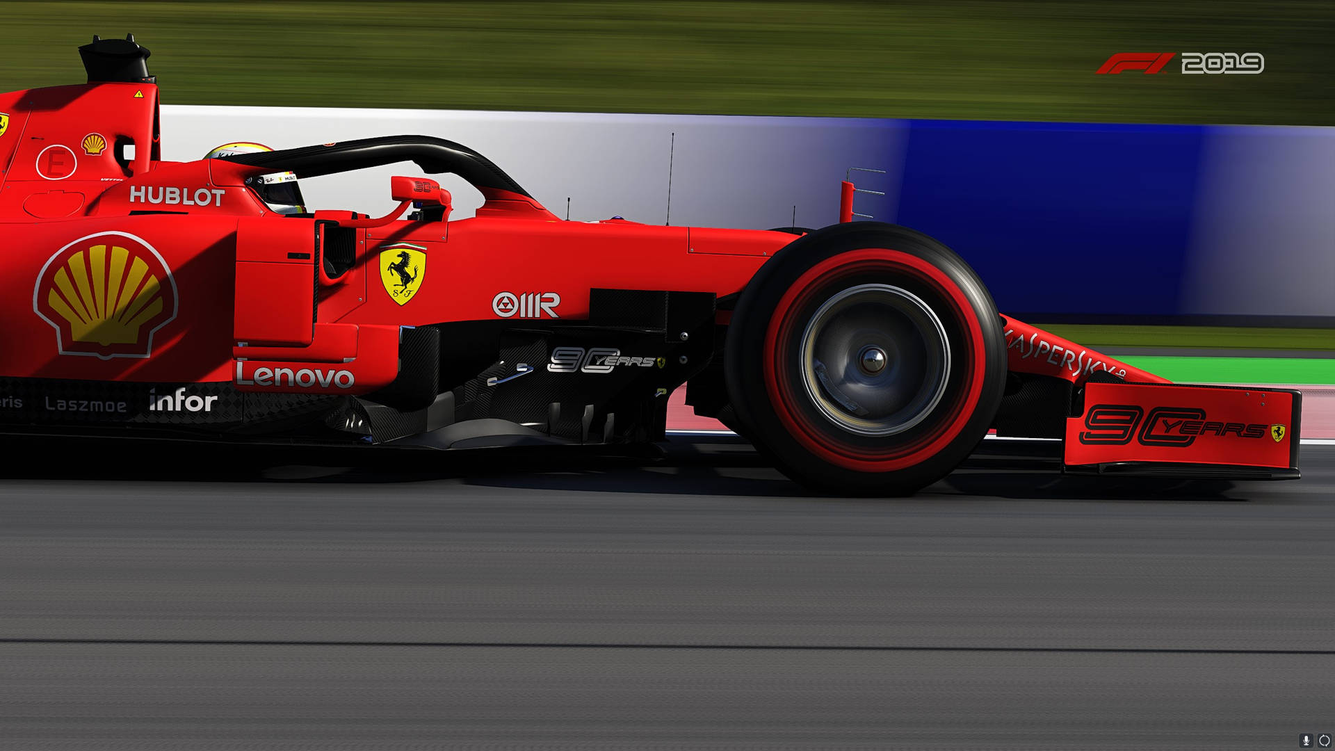紅色法拉利F1賽車在賽道上奔馳，背景模糊。 — F1 2019 壁紙 壁紙