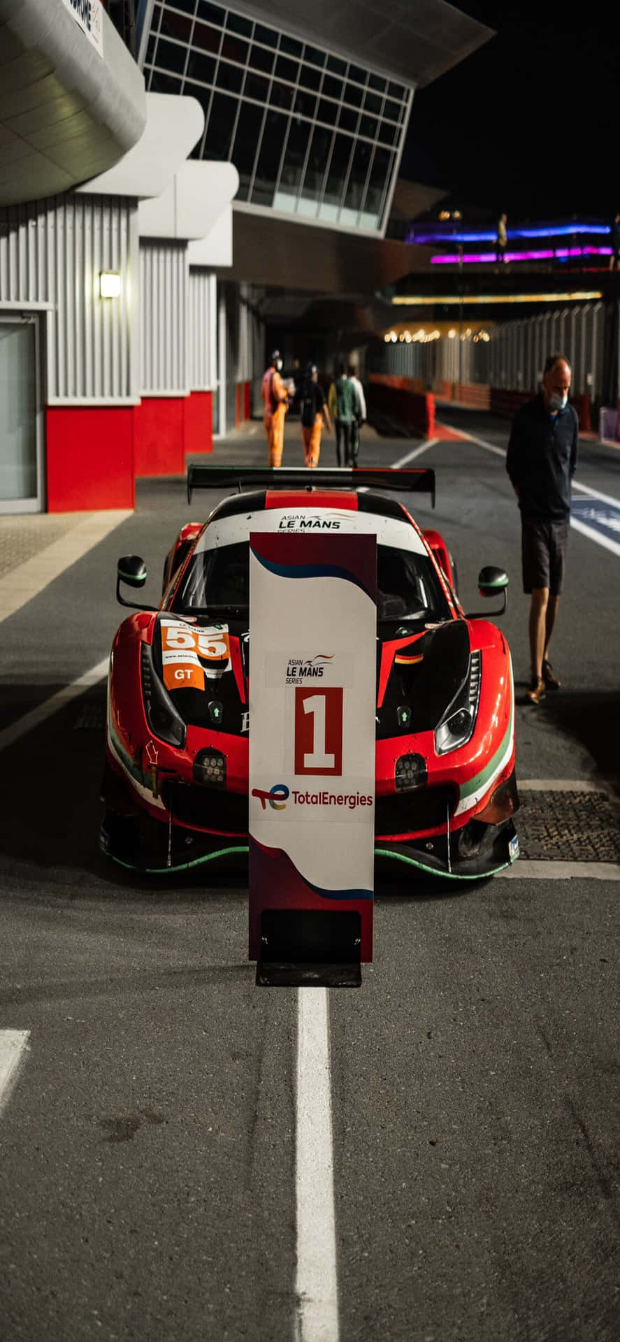 紅色法拉利賽車一號在夜晚停放在現代化維修區。 — Project Cars 2 壁紙