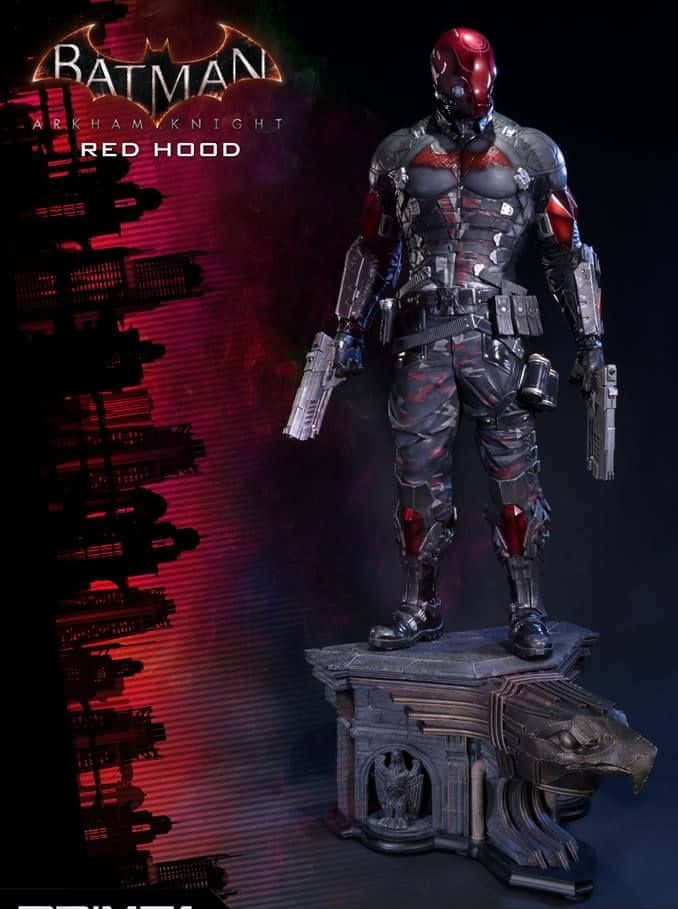 Batman Under The Red Hood 桌布 壁紙 — Red Hood 雕像以雙槍姿態站立，背景是深紅色的高譚市天際線。