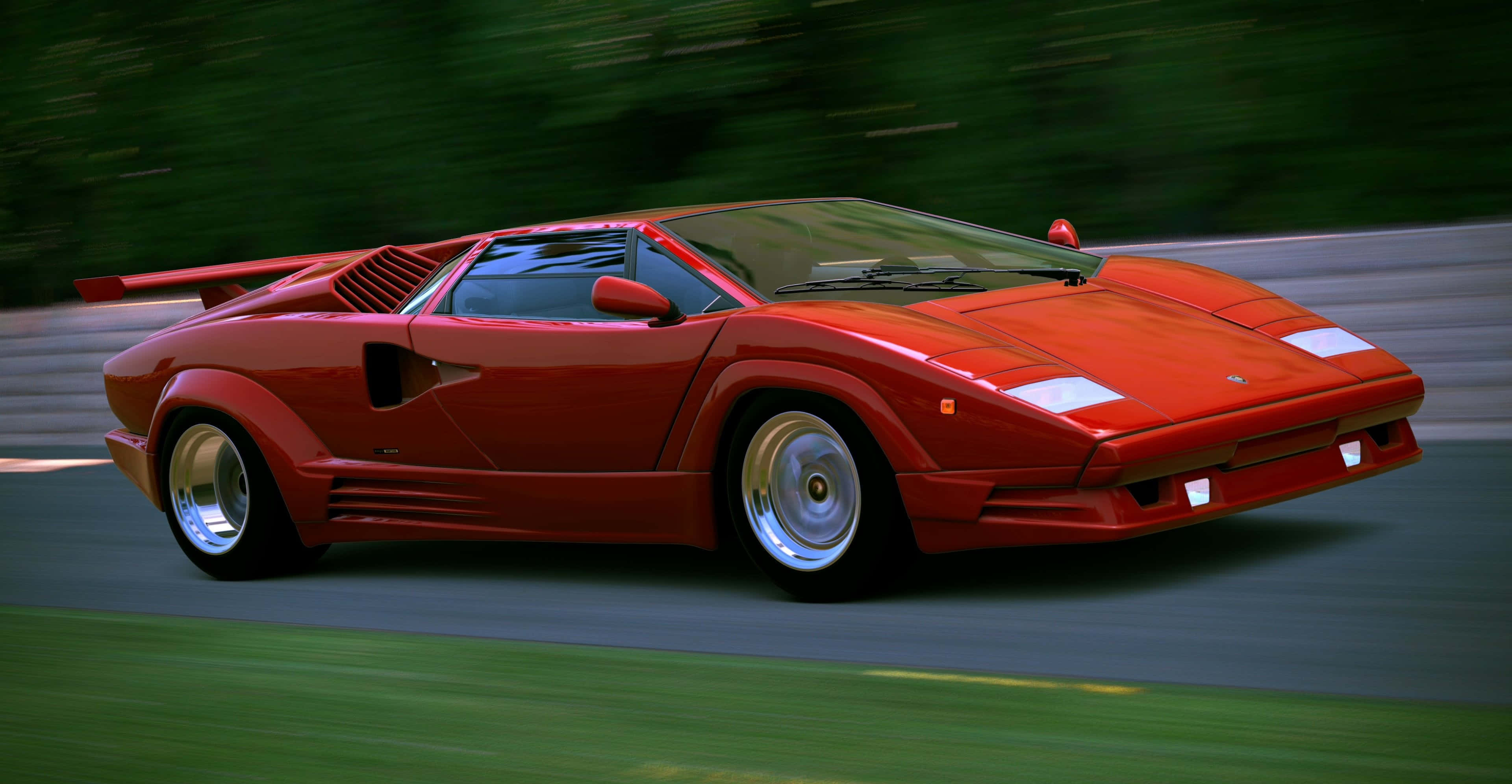 Lamborghini Countach 桌布 壁紙 — 一輛鮮紅色的藍寶堅尼Countach在蜿蜒的道路上疾馳，兩旁茂密的綠植在運動中模糊成影。