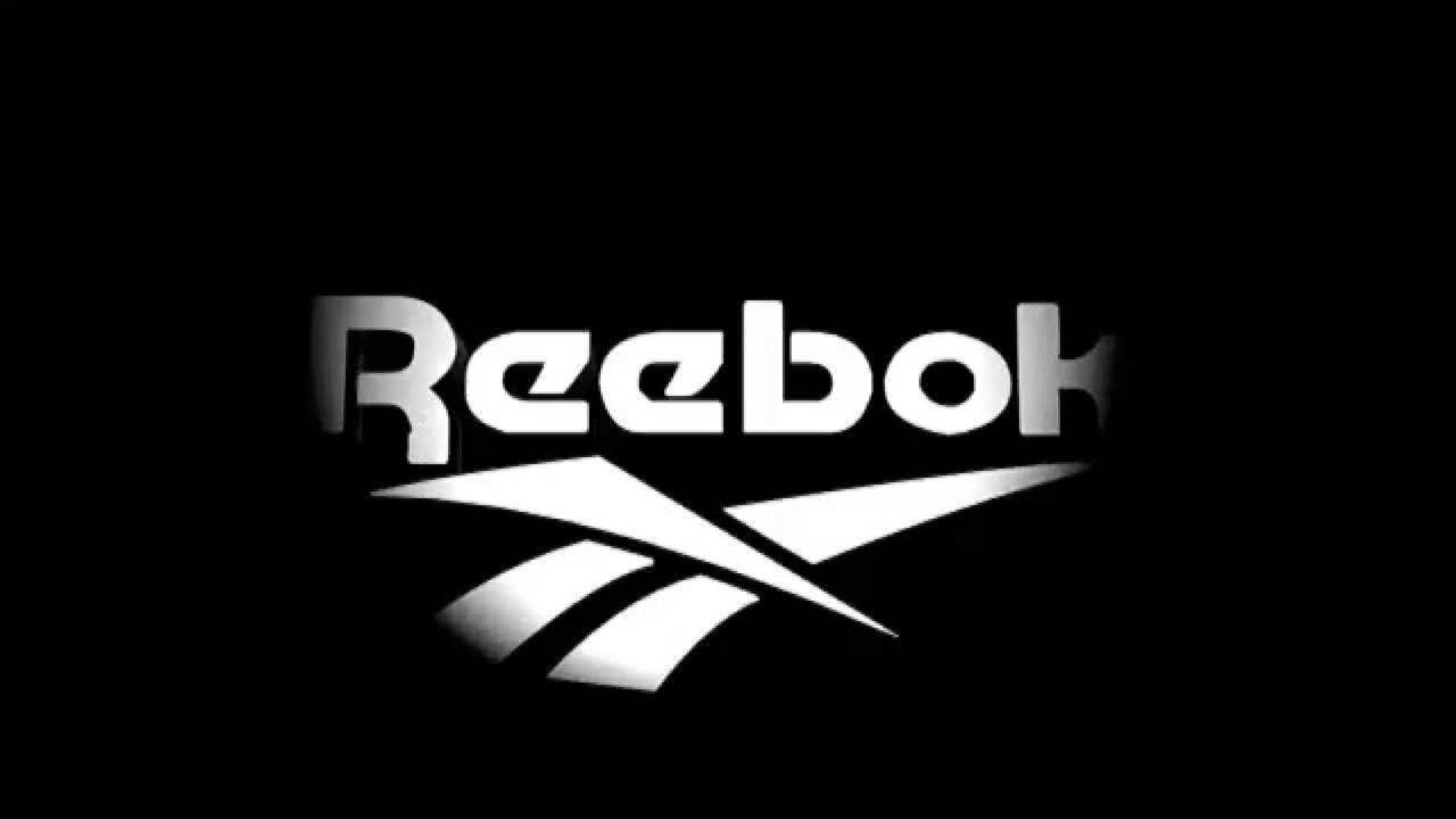 Reebok 桌布 壁紙 — Reebok 標誌在純黑色背景上以純白色發光，帶有微妙的漸變高光。