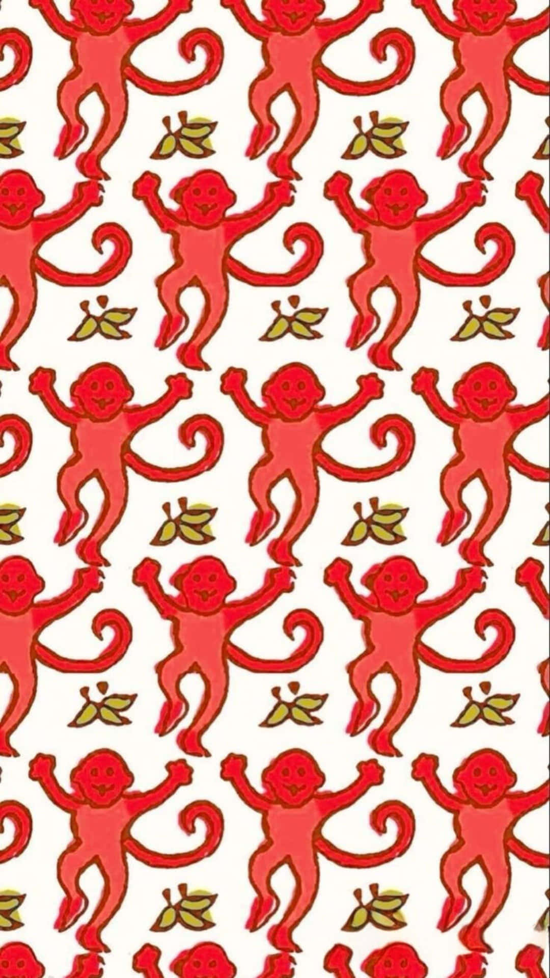  壁紙 — 白色背景上重複的圖案，包含快樂的紅色卡通猴子，帶有彎曲的尾巴和小小的綠色葉子。