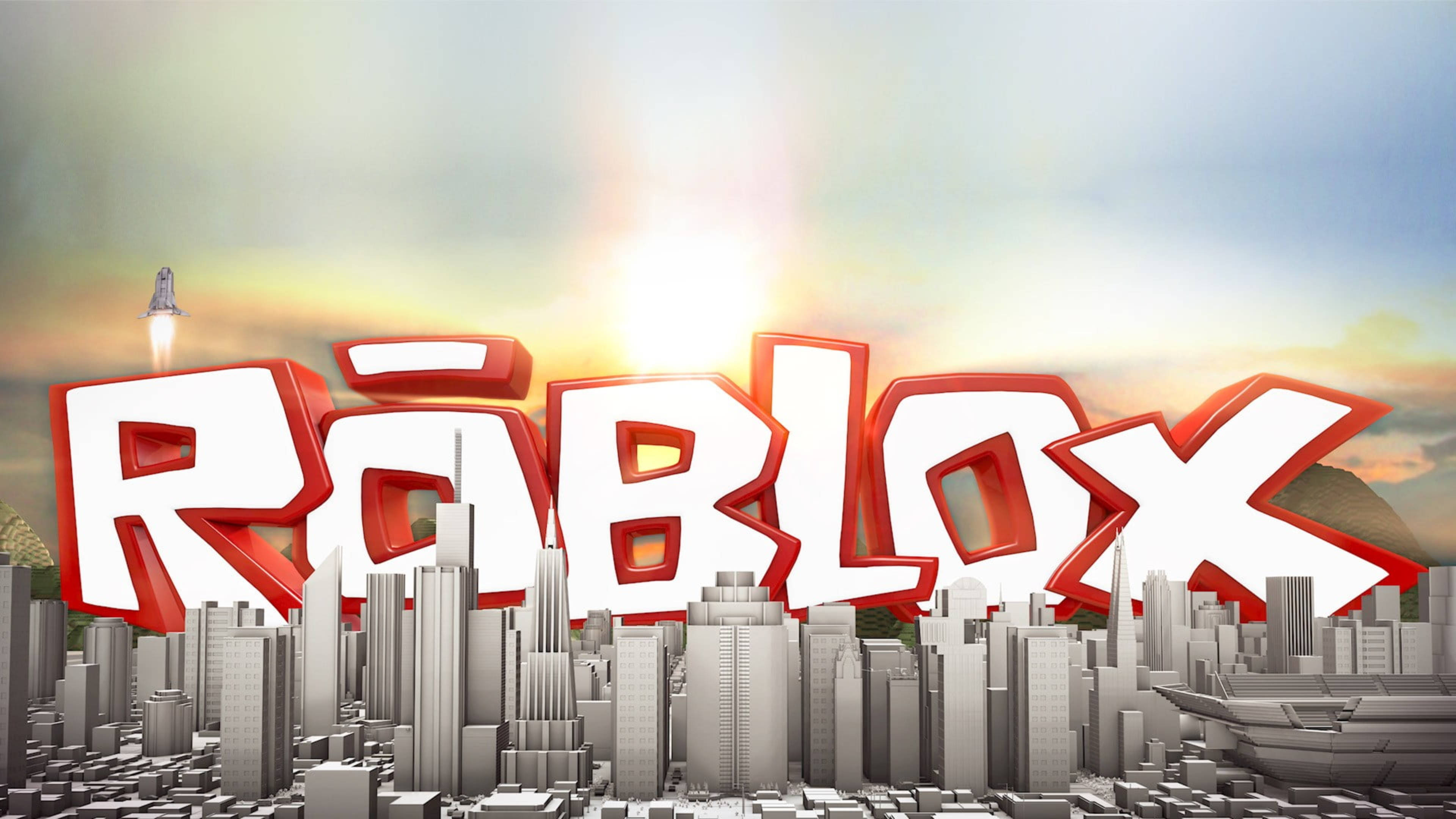 Roblox 桌布 壁紙 — Roblox 標誌以粗體紅色和白色3D字母主導了日落時分的灰階城市景觀，天空中有一枚火箭發射。