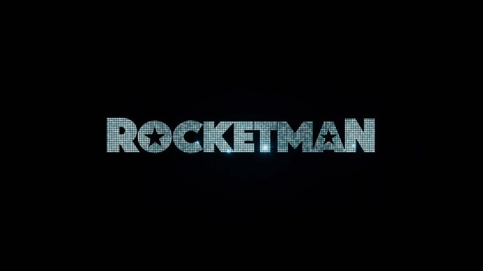 Rocketman 桌布 壁紙 — 「ROCKETMAN」一詞在帶有星星點綴的黑色背景上以閃爍的藍色像素發光。