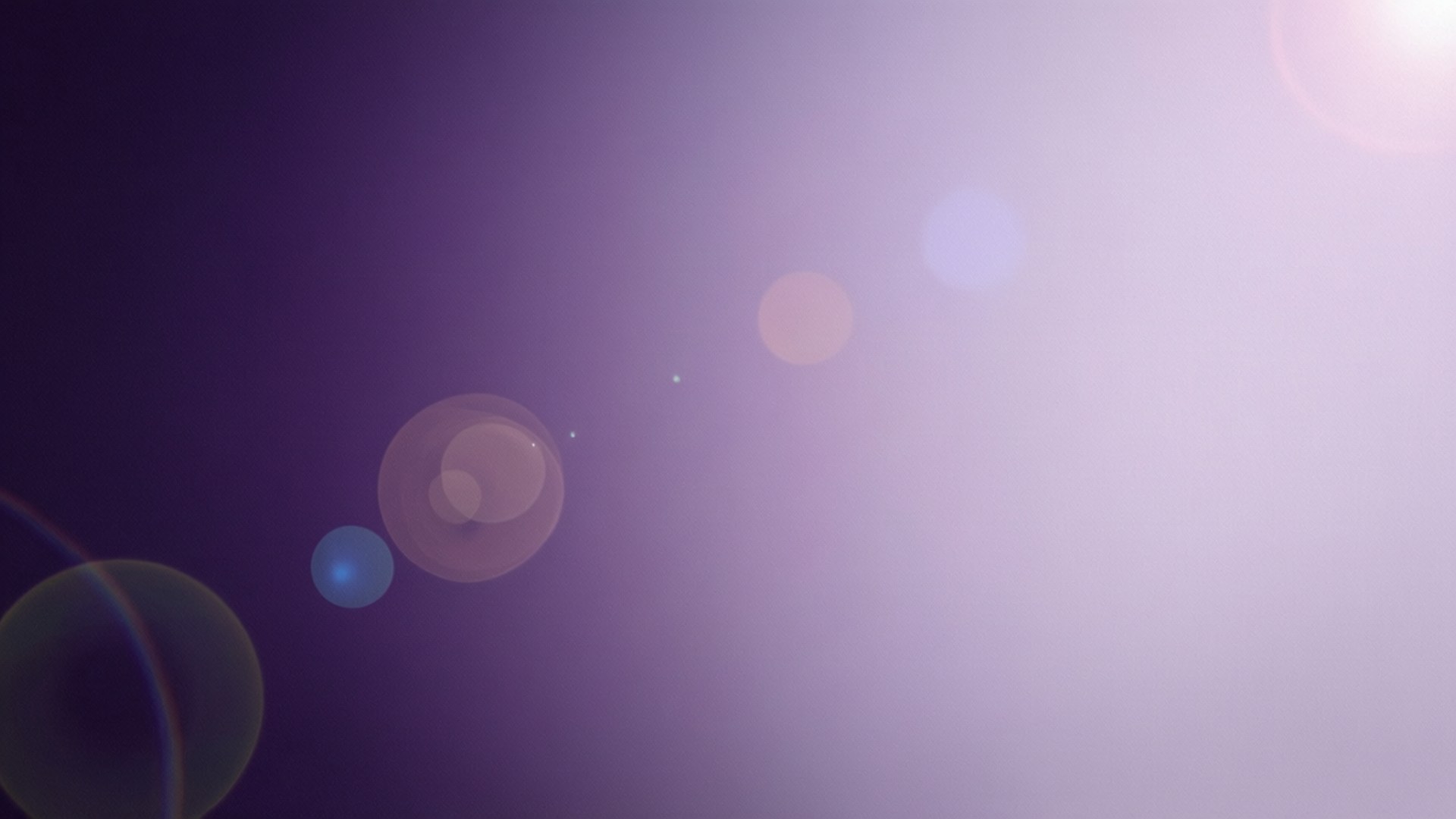Violet Gradient Bokeh 壁紙 — 柔和的紫色漸層背景，散落著鏡頭光暈圓圈，在畫面中輕輕發光。