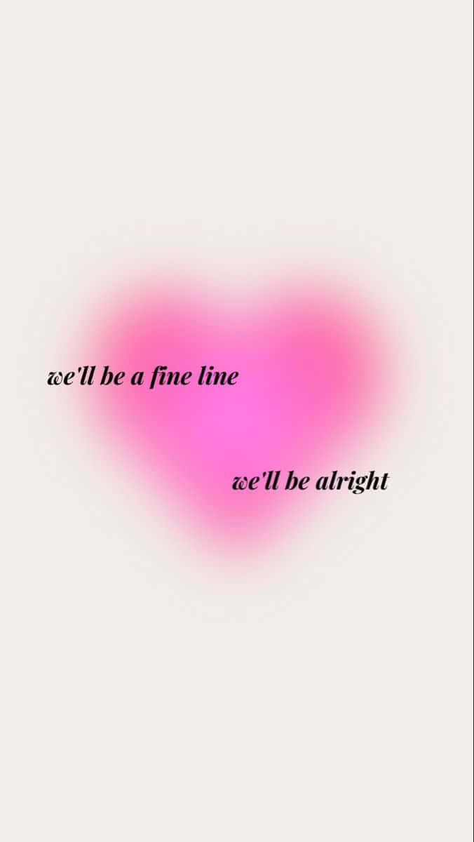  壁紙 — 一個柔和粉紅色模糊的心形，上面有手寫文字「we'll be a fine line we'll be alright」，背景為淺奶油色。