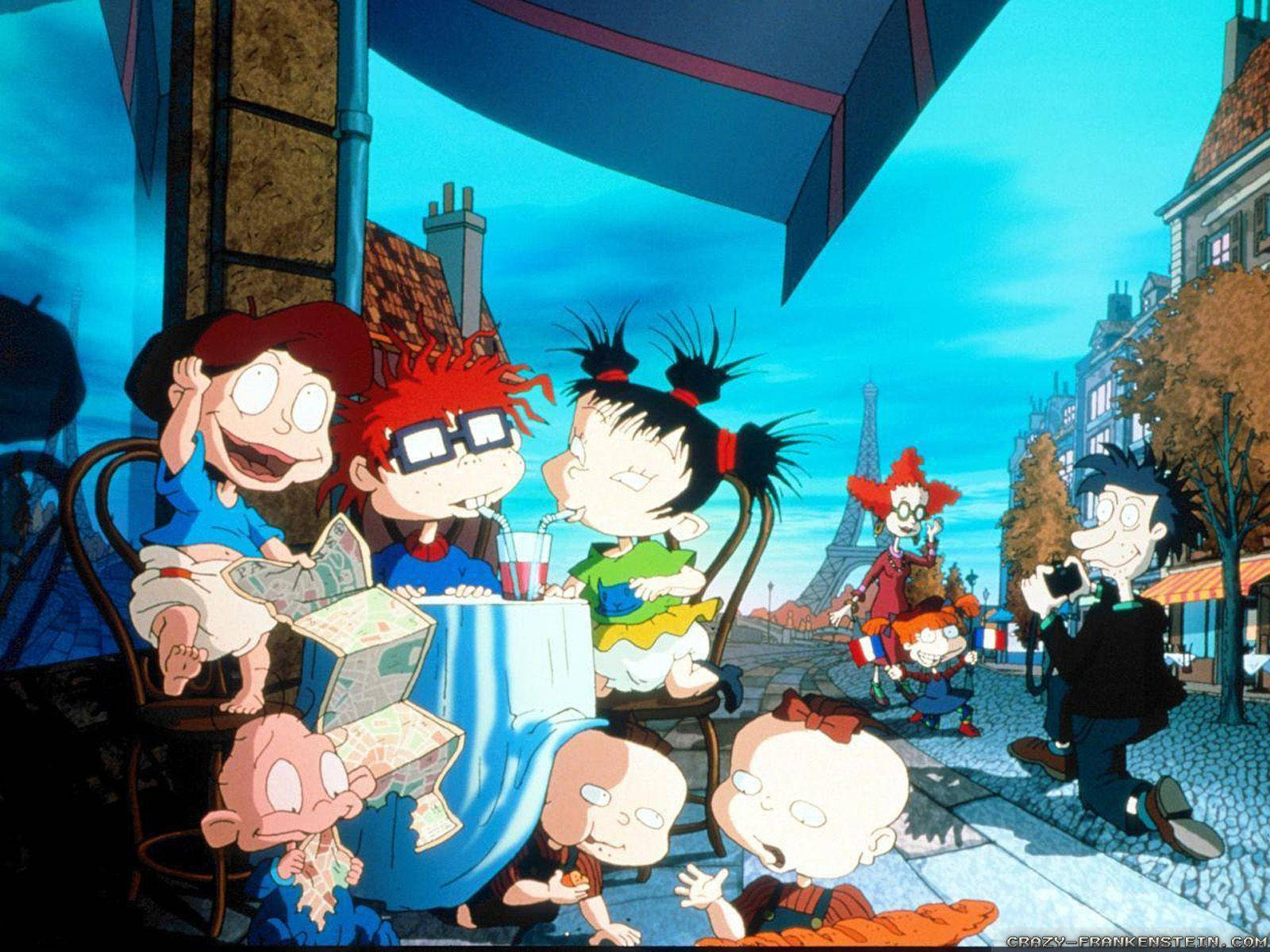 rugrats 桌布 壁紙 — Rugrats 角色聚集在巴黎咖啡館的桌子旁，藍色遮陽篷下，背景是艾菲爾鐵塔。