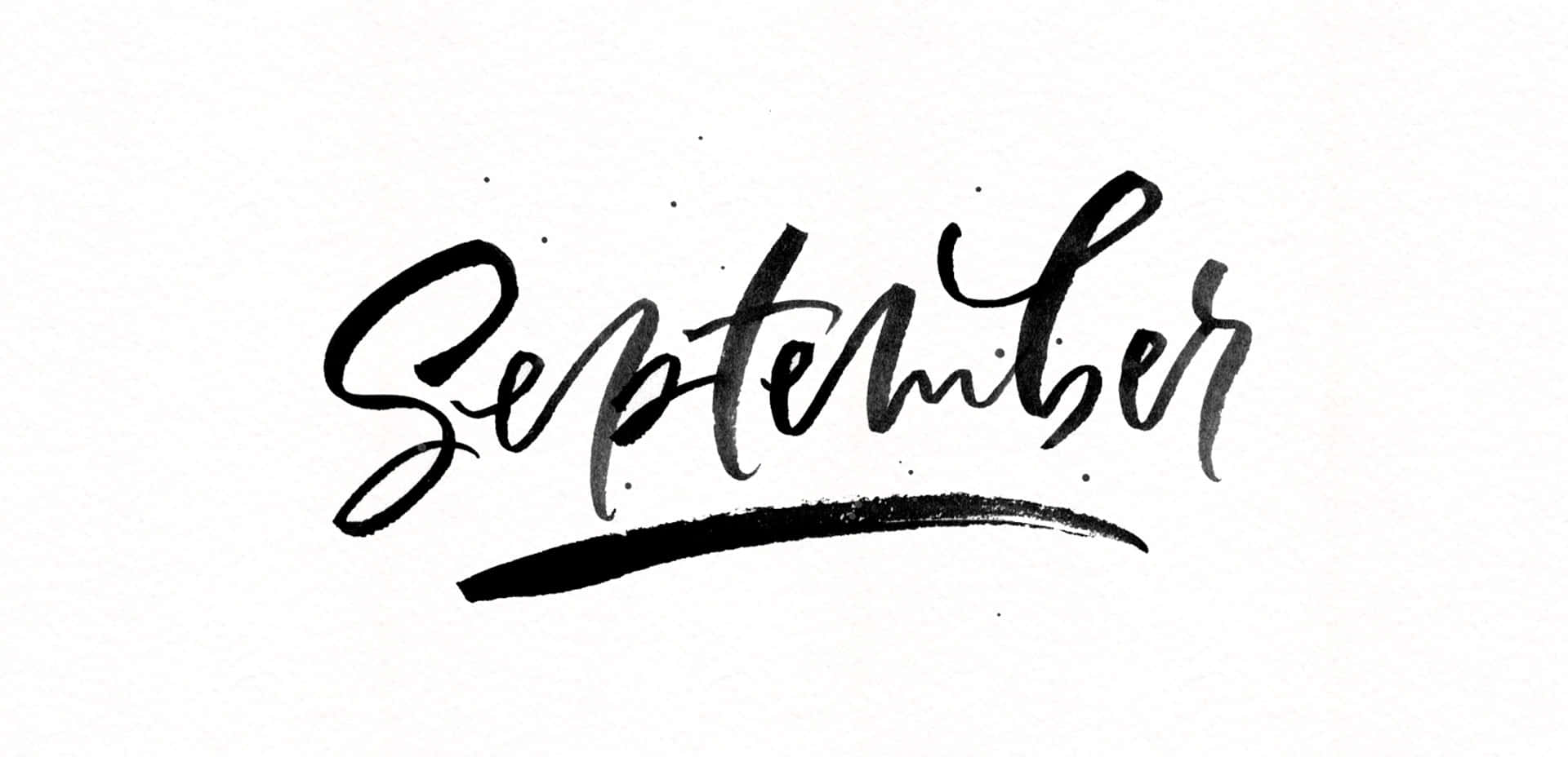 September 桌布 壁紙 — 「September」一詞以粗體黑色毛筆書法書寫，並在帶有紋理的白色紙張上加上流暢的底線。