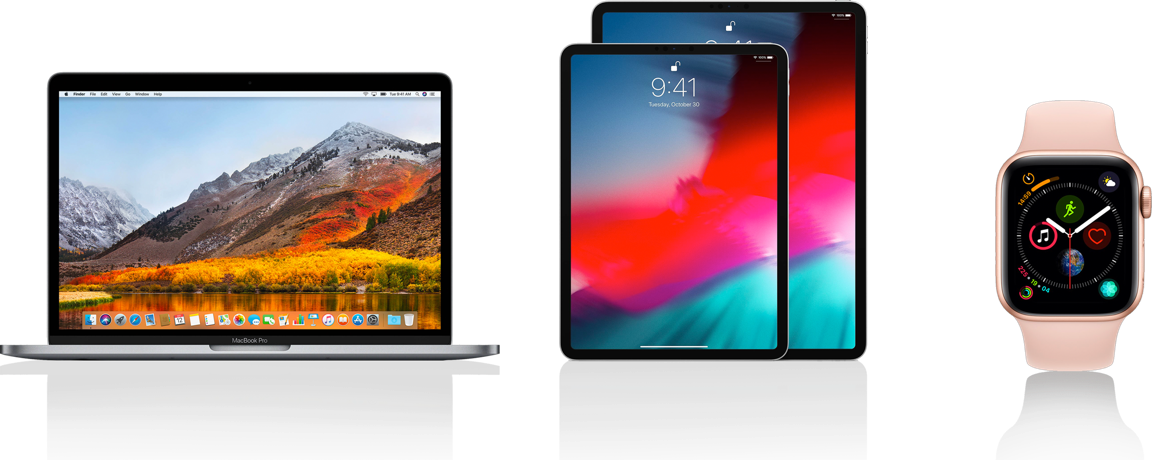Apple 裝置在黑色反光表面上顯示彩色桌布。 — Macbook Pro 壁紙