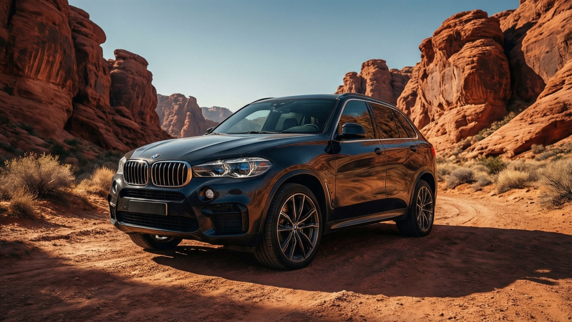 Bmw X5 桌布 壁紙 — 一輛時尚的黑色BMW X5 SUV停泊在塵土飛揚的小徑上，周圍是高聳的紅色岩層，頭頂是清澈的藍天。