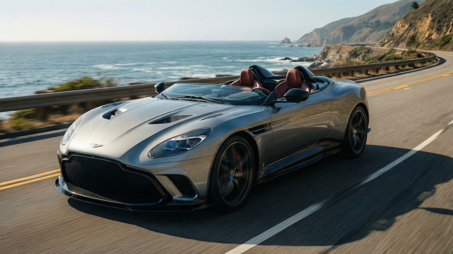 Speedster Coast 壁紙 — 一輛銀色Aston Martin DBS Superleggera敞篷跑車沿著海岸高速公路疾馳，背景是海洋懸崖和波浪。
