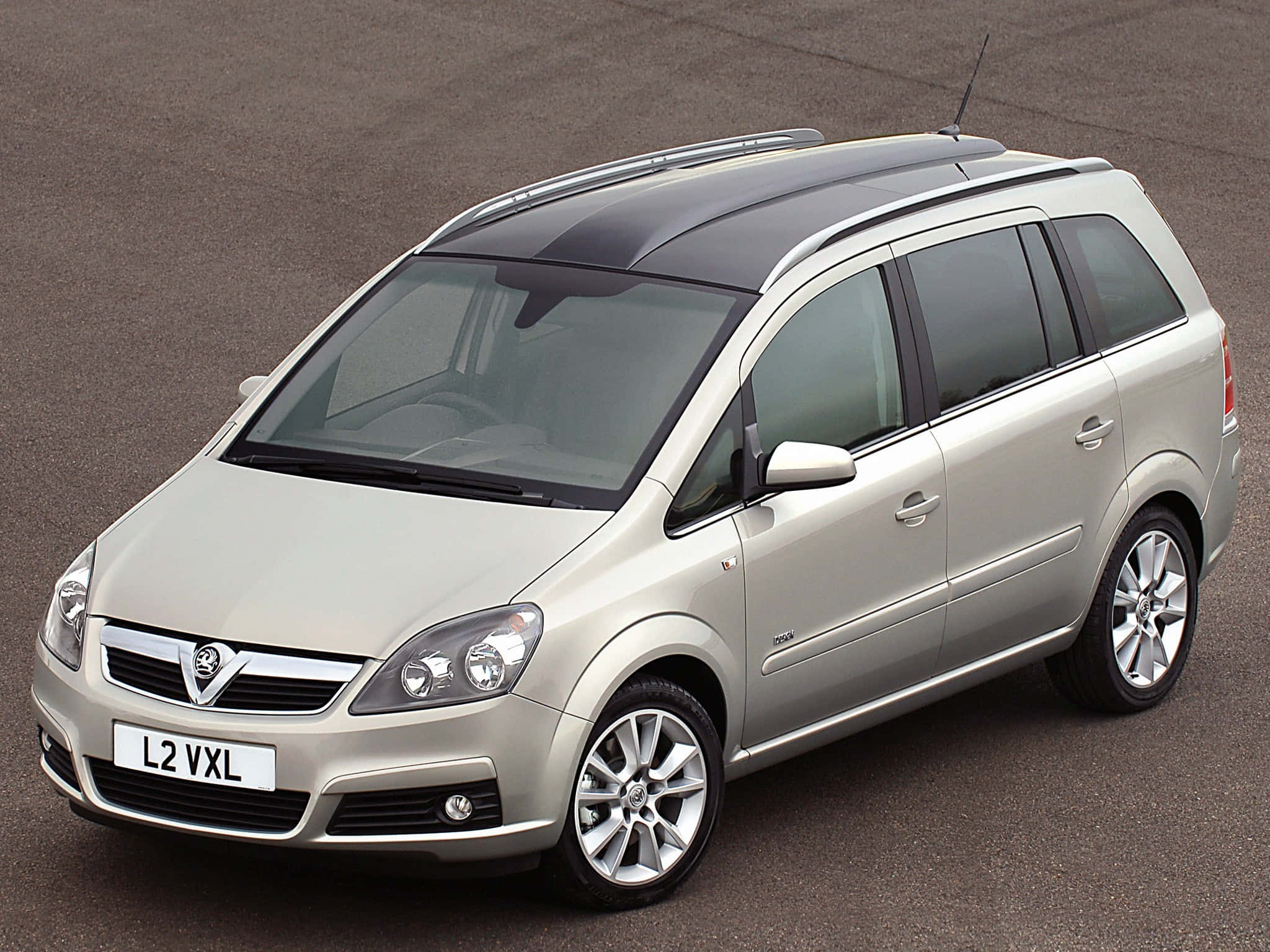 Opel Zafira 桌布 壁紙 — 一輛銀色 Vauxhall Zafira 旅行車停在柏油路上，配有車頂行李架和有色車窗。