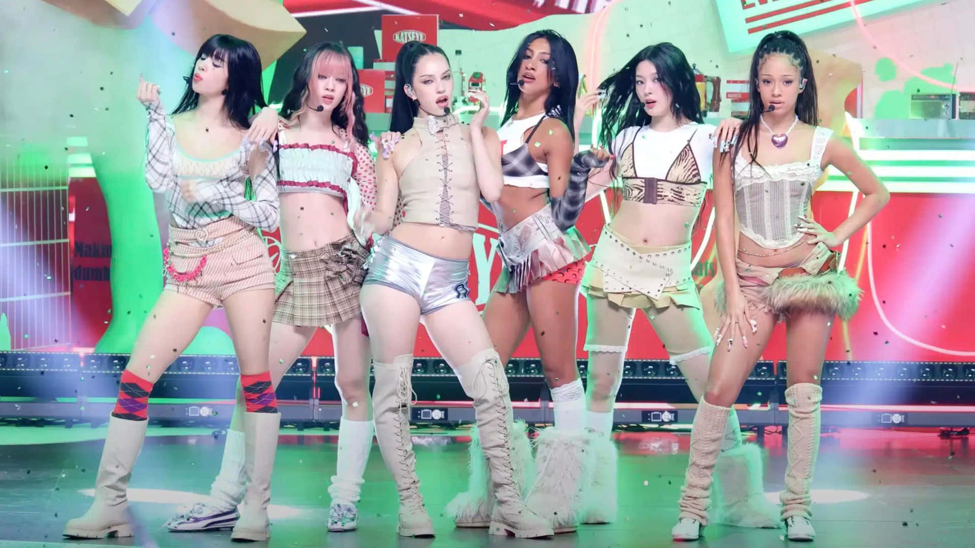  壁紙 — 六位女性表演者在充滿活力的霓虹燈舞台上，以色彩繽紛的幾何背景和飄落的五彩紙屑擺出動感姿勢。