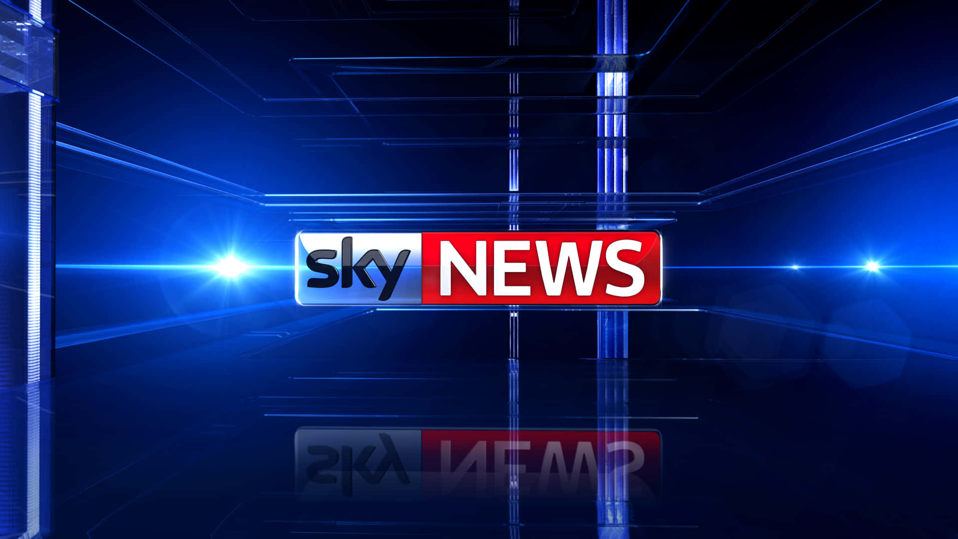 高清 桌布 壁紙 — Sky News 標誌在未來感十足的藍色攝影棚中發光，帶有鏡頭光暈和反光地板。